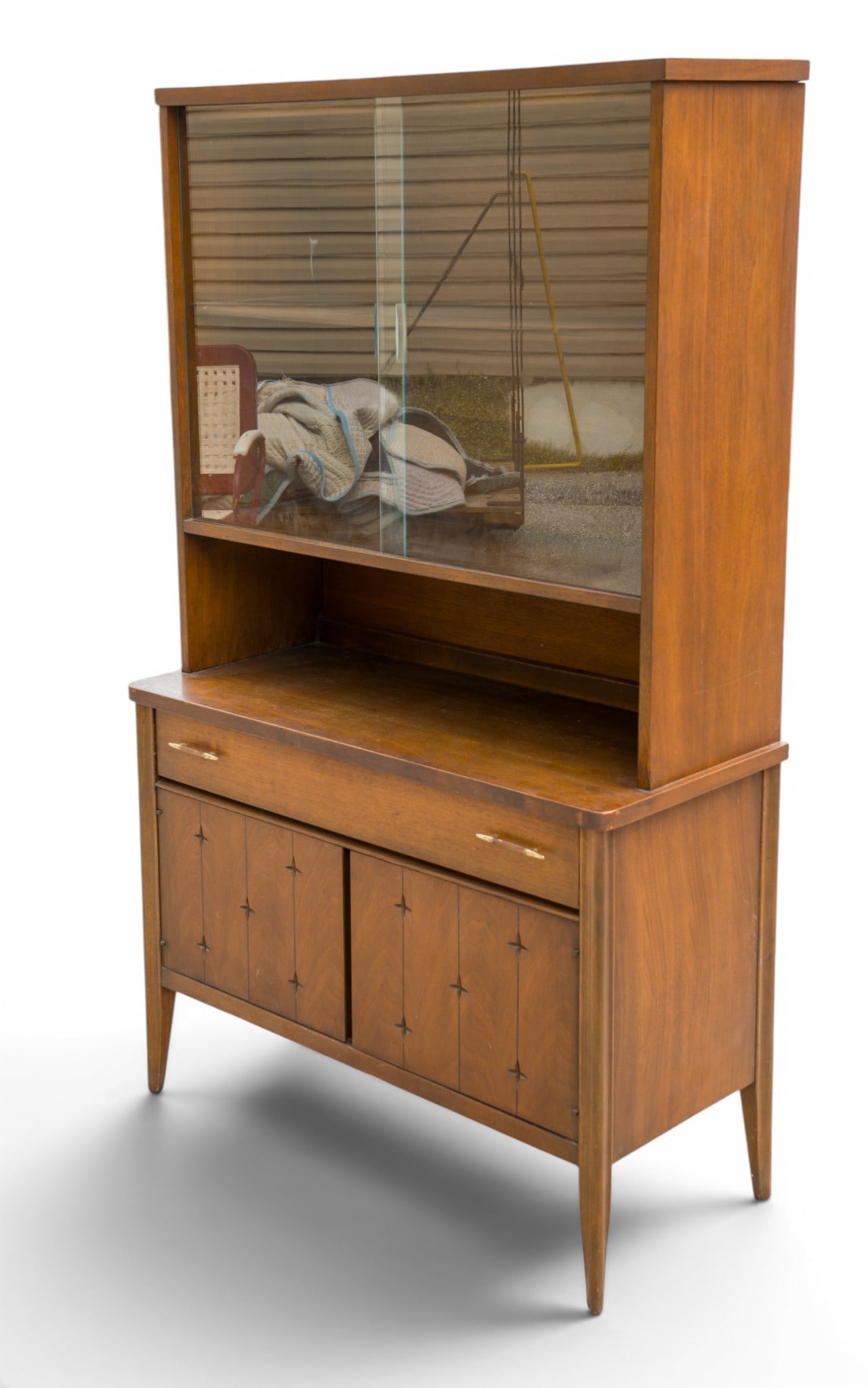 Broyhill Saga China Cabinet Mid-Century: Broyhill Saga dish / china cabinet featuring a mid-century geometric motif and front door star design. The cabinet measures approximately 39 inches wide, 17 inches deep, and 65 inches high. Design