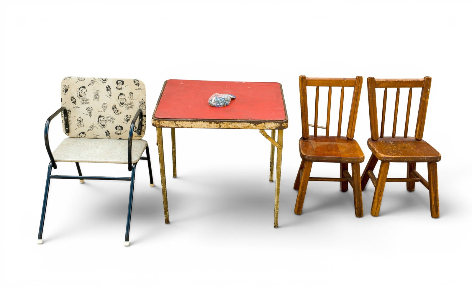 Child Size Vintage Furniture Grouping: Four vintage children's items: two wooden chairs (11 in W x 11 in D x 23 in H each), one metal folding card table with a red top (23 in W x 23 in D x 21 in H), and one Howdy Doody-themed chair-to-desk