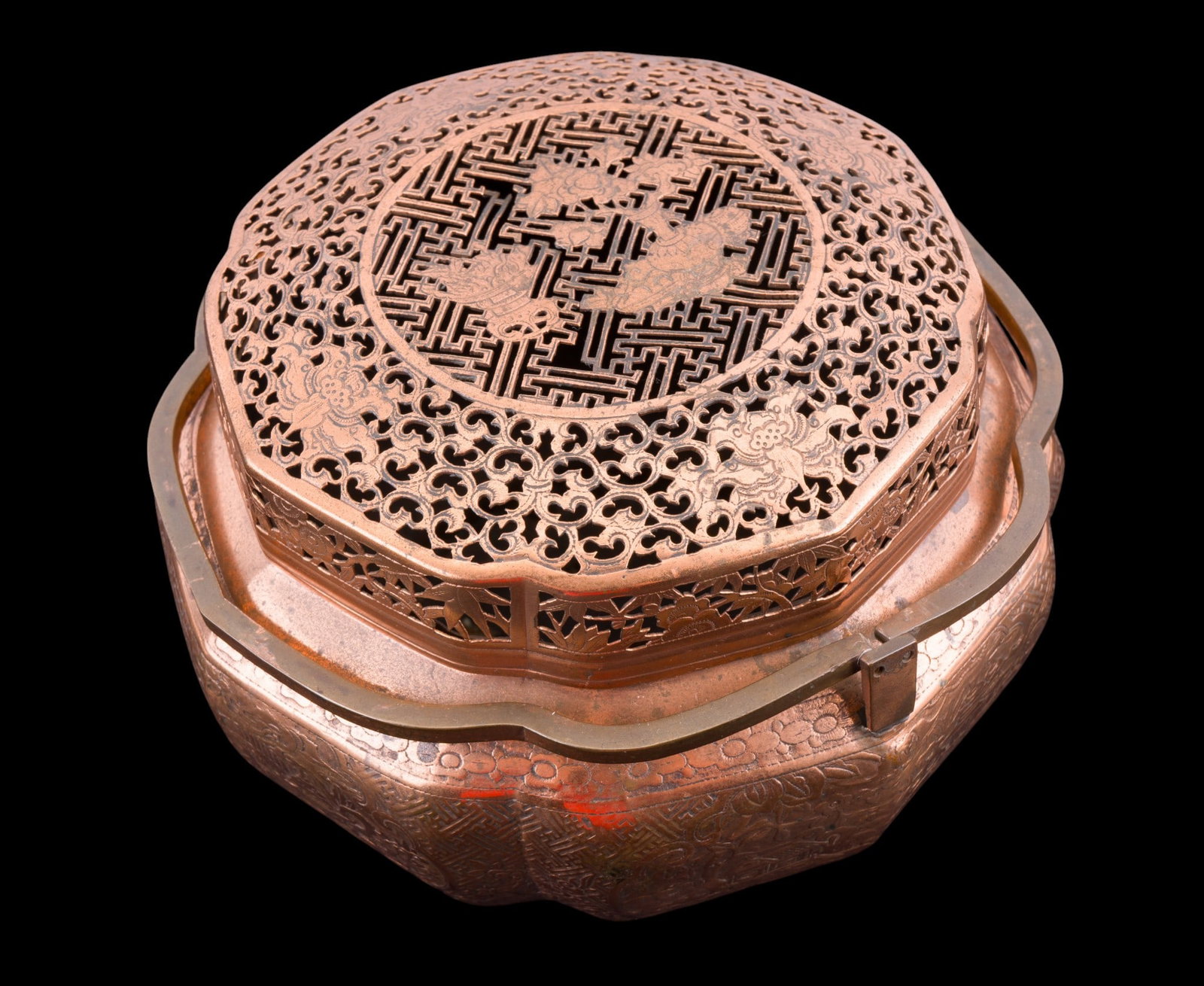 Chinese Early Copper Censer w/ Handles: An early Chinese copper censer with reticulated decoration on lid and relief measuring approx. 5.5" high x 8" diameter.