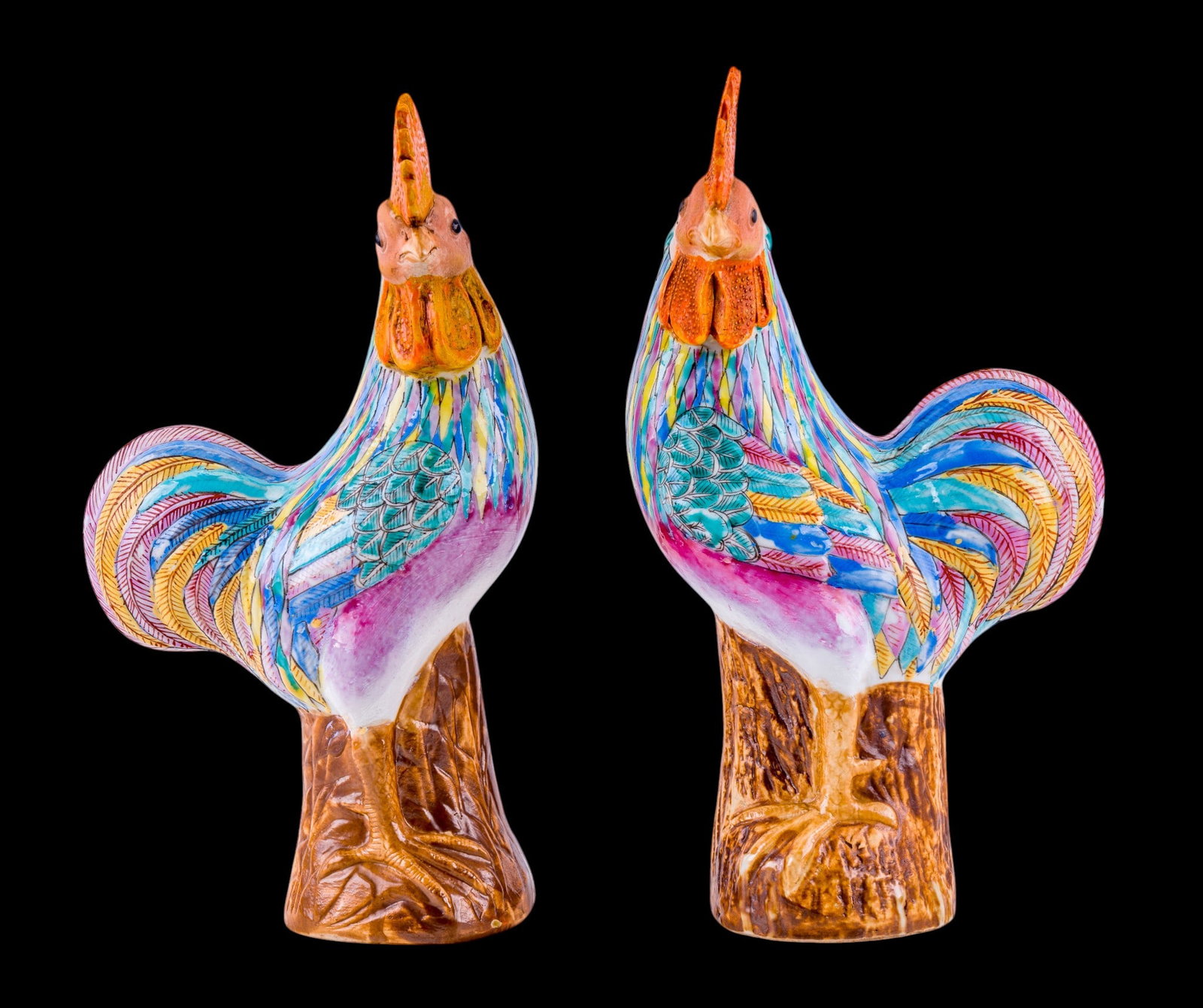 Pair of Chinese Porcelain Roosters: Pair of Chinese porcelain rooster figures, each modeled standing naturalistic tree stump bases with brighly enameled multicolor plumage and impressed character marks to underside. Each measures