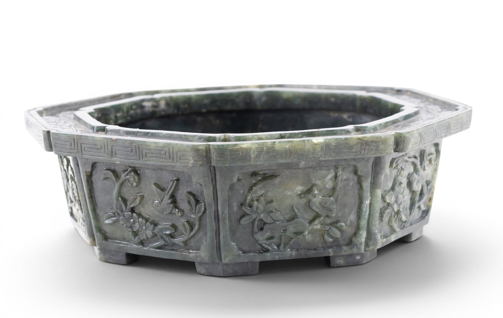 19th C Spinach Green Jade Planter's Pot: A Spinach jade patterned planter's pot measuring approx. 3" high x 9.5" diameter. Square chopmark present on bottom as seen in photography. Octagonal shape, with panels on each side depicting flowers