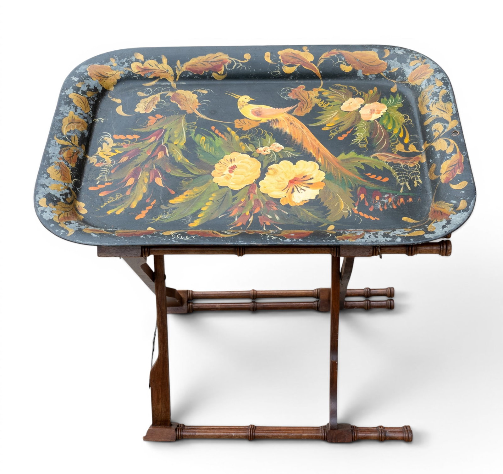 19th C Tole Painted Tray w/ Folding Wood Stand: A 19th C hand painted Tole metal tray depicting peacocks and flowers, note some loss, measures approx. 23.5" W x 17.25" H, turned wood stand measures approx. 19" H x 25" W, flattened, note loss to