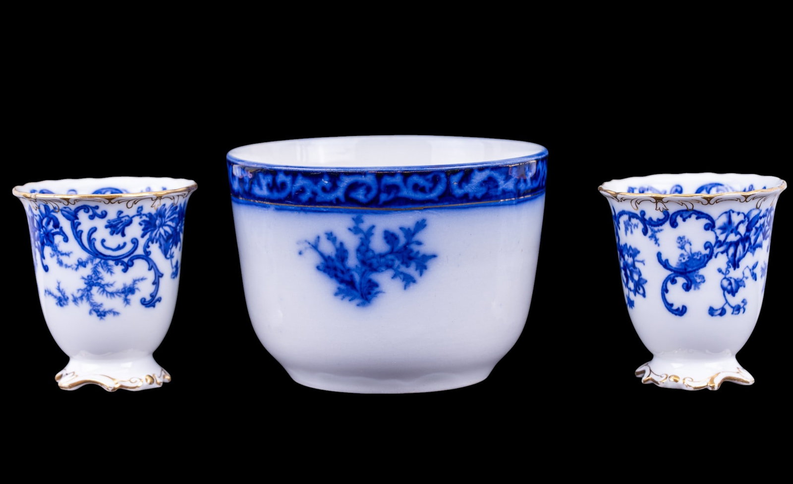 Touraine Flow Blue Bowl and Cauldon Porcelain Cups: A Touraine flow blue floral decorated bowl, measures approx. 5" diam x 3.5" H and two blue and gold floral decorated porcelain cups by Cauldon England.