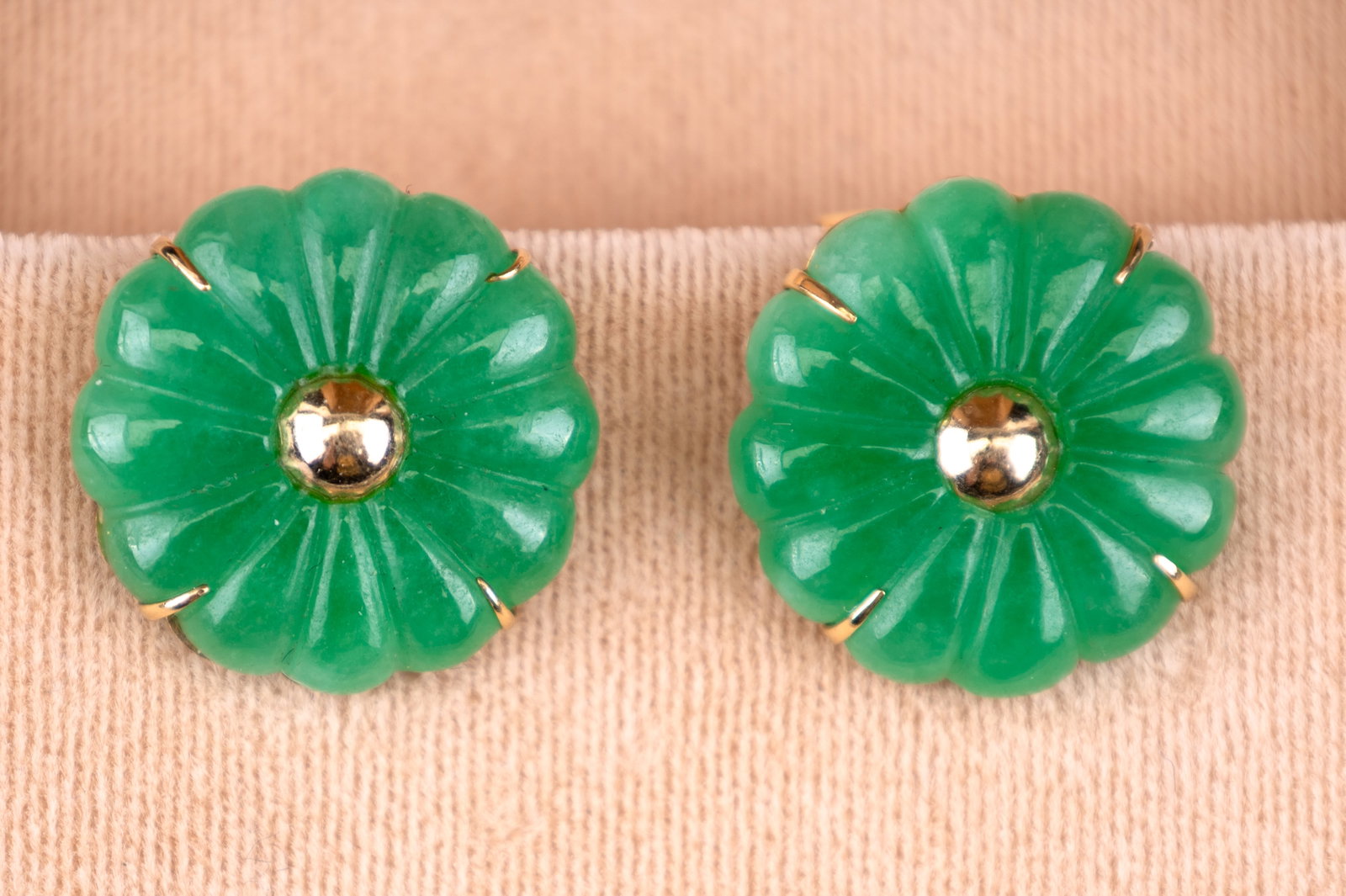 14K Gold Jade Flower Earrings: A pair of jade and 14K gold post earrings in a flower design and marked HK 14K on backs. Approx. total weight is 10g.