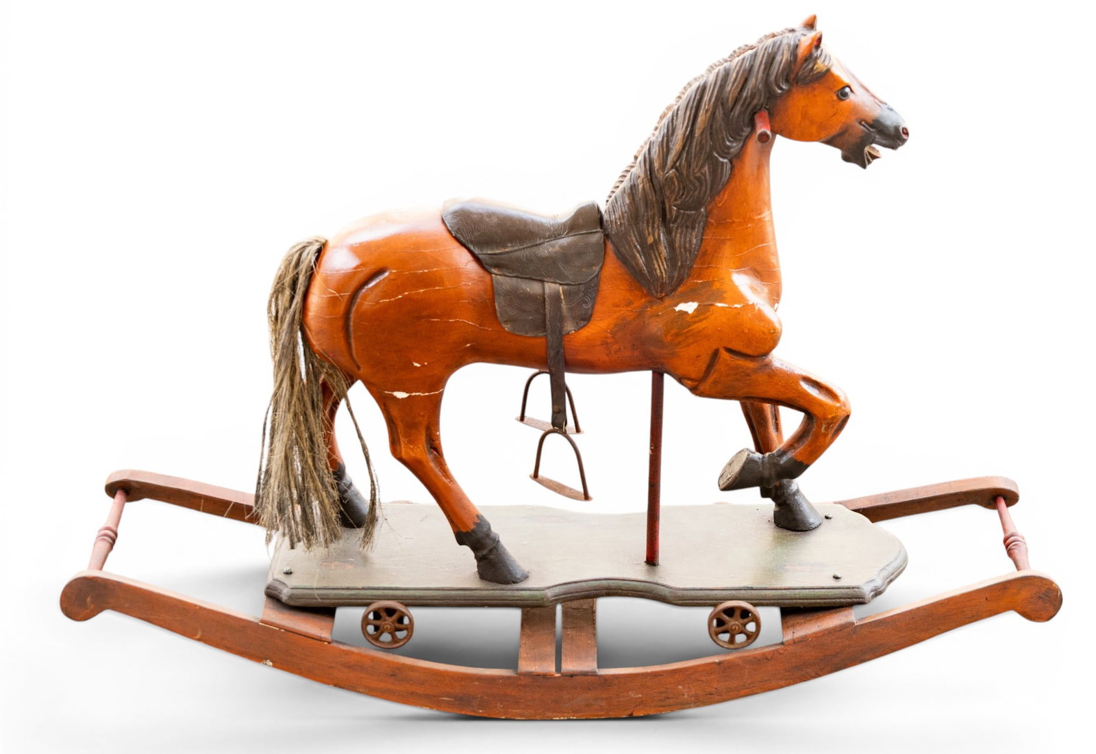 Antique Rocking Horse with Saddle: Antique wooden rocking horse featuring a hand-carved design with painted details. Includes a carved mane, tail, and movable rockers. Saddle and stirrups are intact, though the horse shows wear consist
