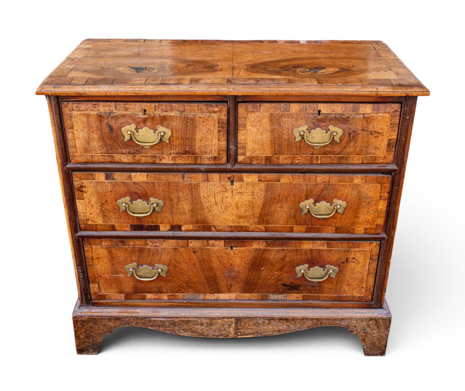 Bachelors Chest w Oyster Inlay: Bachelor's chest featuring 2 short over 3 long drawers, oyster veneer top with crossbanded border, paneled back. Measures approx. 35.75" W x 17.25" D x 32.5" H.