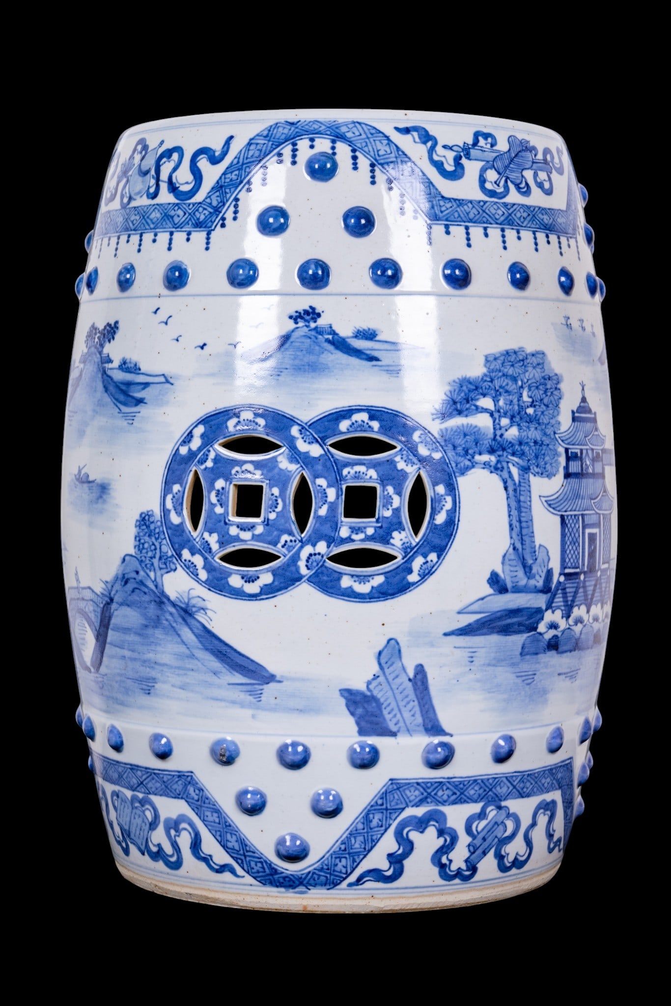 Chinese Blue and White Porcelain Stool: Chinese porcelain garden stool of barrel form with cobalt blue transfer-decorated landscape scenes, raised boss decoration, and pierced top and side openings. Measures approx. 18.5" H x 12" Diameter.