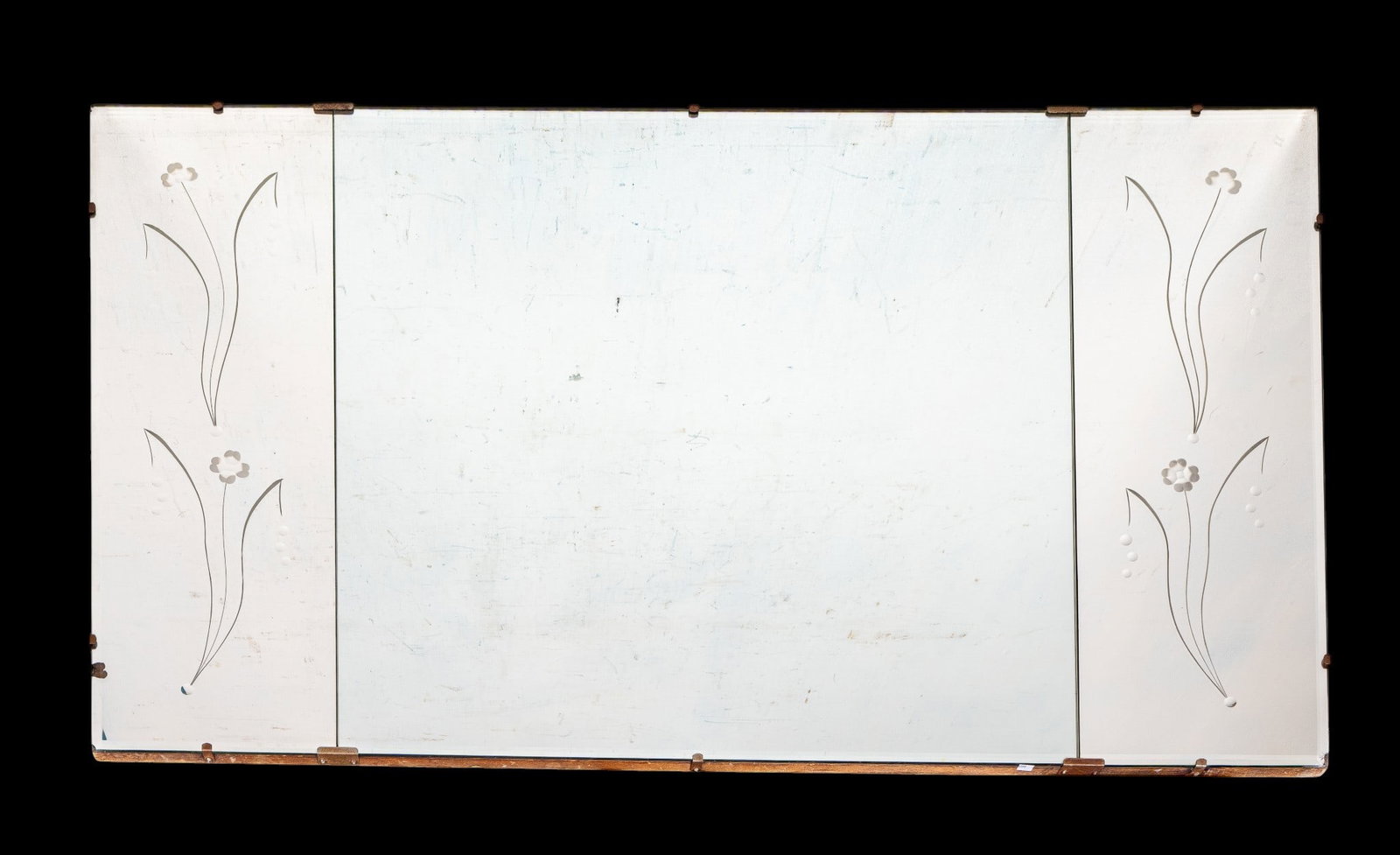 Vintage Etched Beveled Wall Mirror: A large vintage beveled wall mirror featuring separate left and right sections with etched floral design, note chip on lower right corner, measures approx. 60" W x 36" H. Special considerations should
