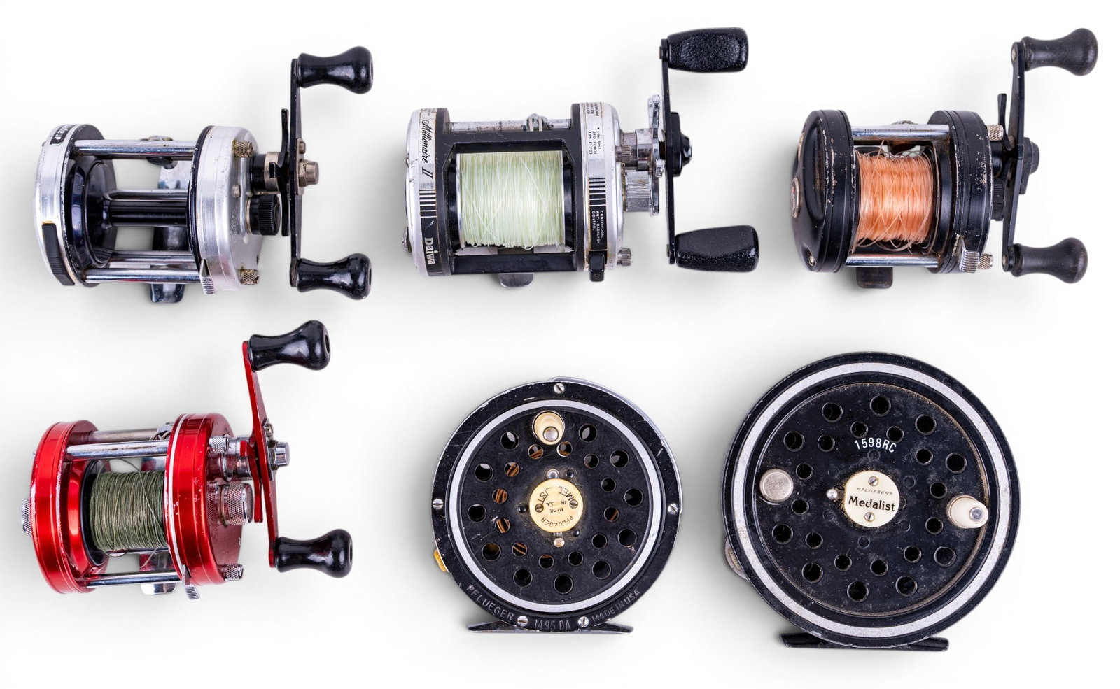 6 Vintage Fishing Reels, Abu Garcia, Daiwa, More: Collection of 6 vintage fishing reels including an Abu Garcia Ambassadeur Five baitcasting reel, Daiwa Millionare II 600M hi-Speed baitcasting reel, Pflueger Medalist 1598RC, and several other Abu