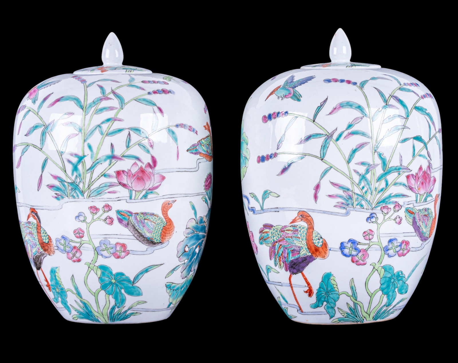 Pair of Chinese Porcelain Lidded Ginger Jars: Pair of Chinese porcelain lidded ginger jars decorated with lotus blossoms, lily pads, birds, and dragonflies in famille rose enamels on a white ground. Marked to underside with iron-red seal mark.