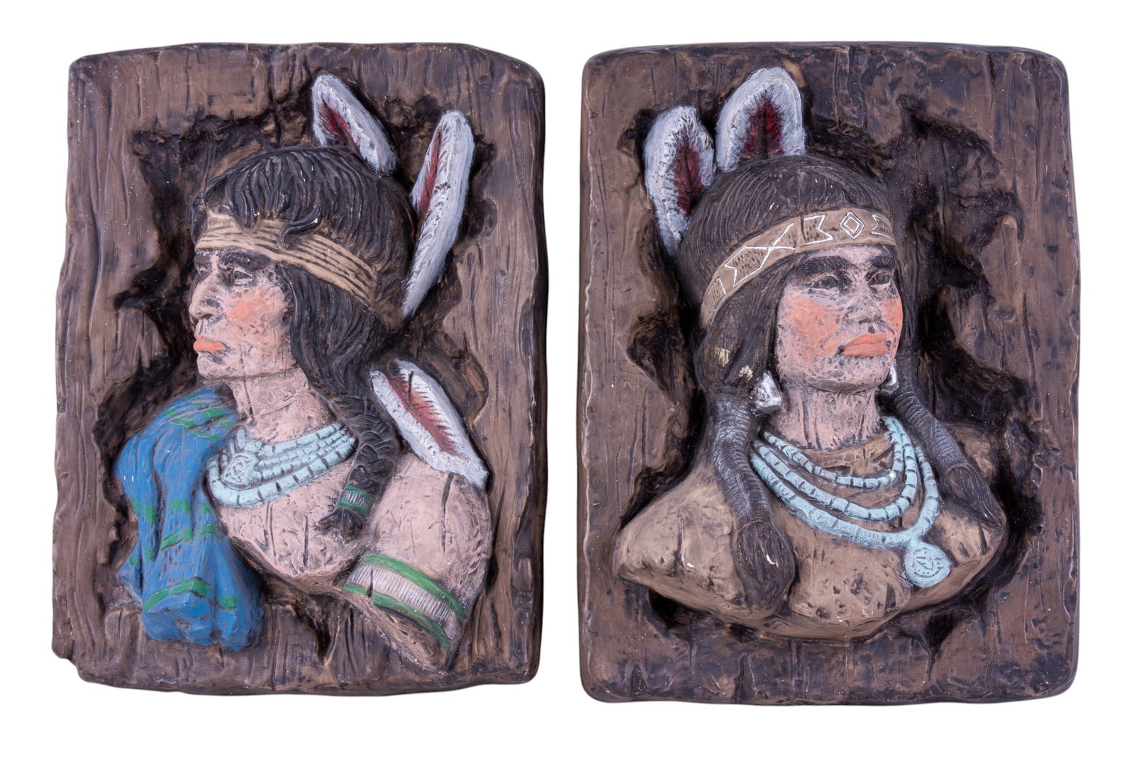 Pair of Vintage Chalkware Native American Plaques: Two molded and hand-painted chalkware wall plaques depicting Native American figures in relief with faux wood backgrounds. Each measures approx. 11" W x 14.25" H.