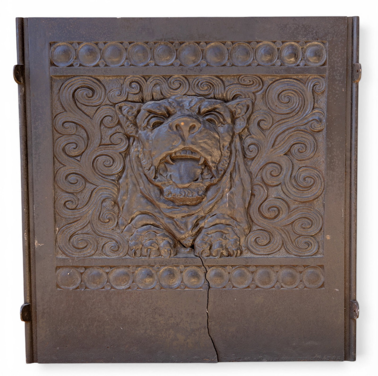 Rare Antique Hound Relief Cast Iron Fire Back: A rare antique cast iron fire back depicting a relief of a snarling hound / bull dog face, note significant crack from the bottom. Measures approx. 33" W X 33" H. Special considerations should be