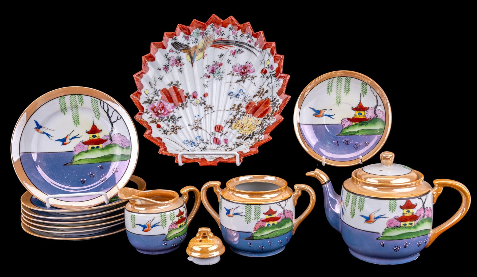 Vintage Japanese Lusterware, Signed Kutani Plate: Partial vintage Japanese lusterware service, each with green leaf patterns and finished with blue glaze to lower portion, comprising 7 dessert plates, 1 saucer, 1 cream and sugar, and 1 lidded