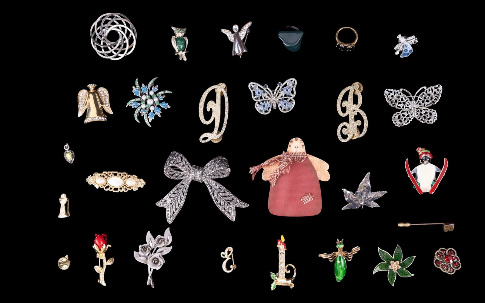 Vintage Brooches: A collection of vintage brooches including designer brands such as Monet and Liz Claiborne, featuring vintage styles with rhinestones, enamel, and gold and silver tone.