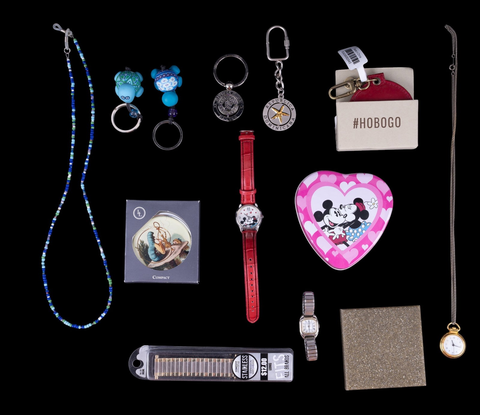 Disney Watch and More: A collection of souvenir keychains, a Caravelle M8 ladies wrist watch, a Disney Special Edition Mickey and Minnie 'Kissing Time' watch with red leather band, in original heart shaped tin and box, and