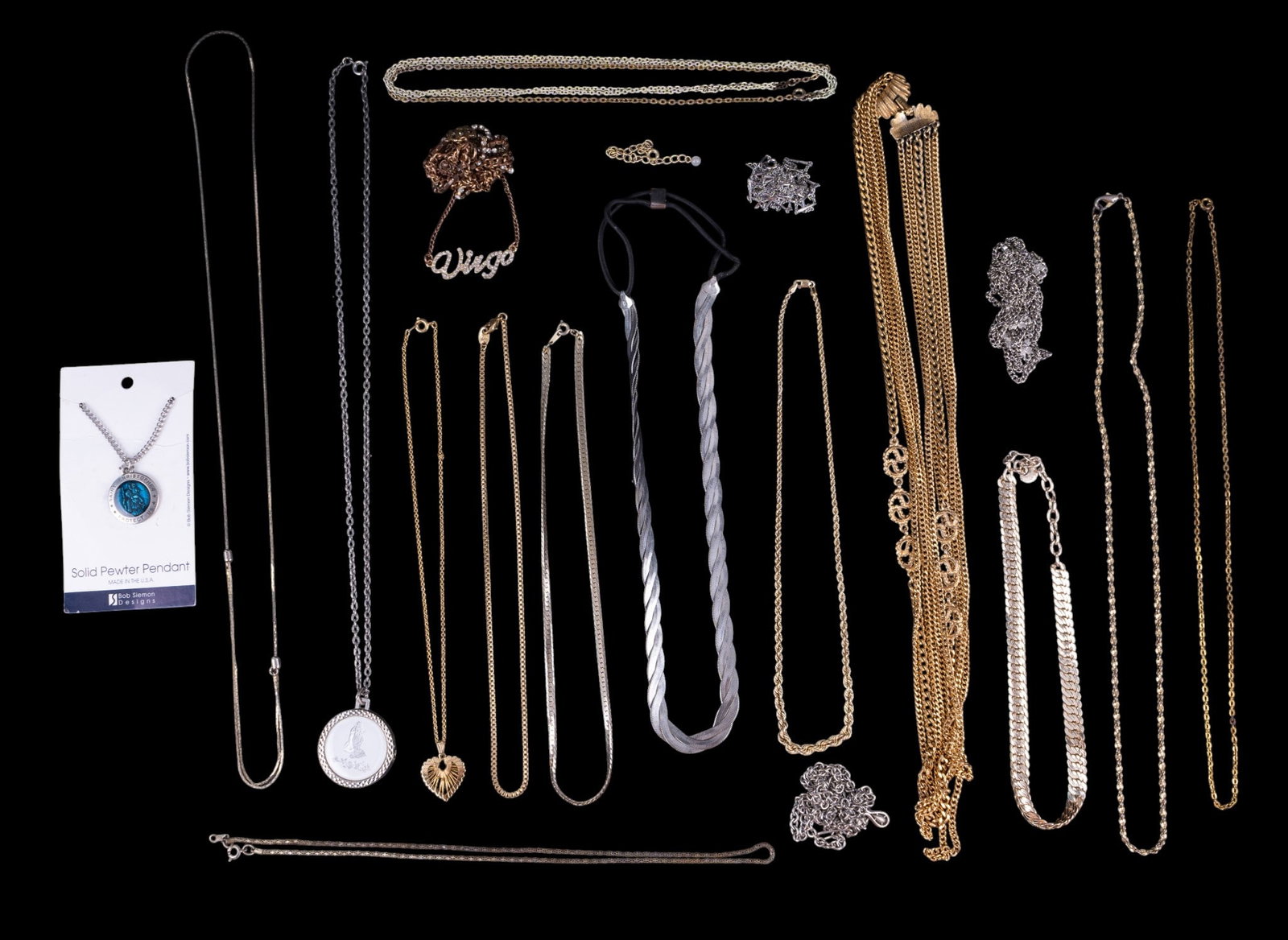 Vintage Gold and Silver Tone Chains and Necklaces: A collection of various styles of gold and silver tone chains and necklaces featuring styles such as multi strand, box chain, braided twist, Herringbone, Religious medallions, and more. Longest item