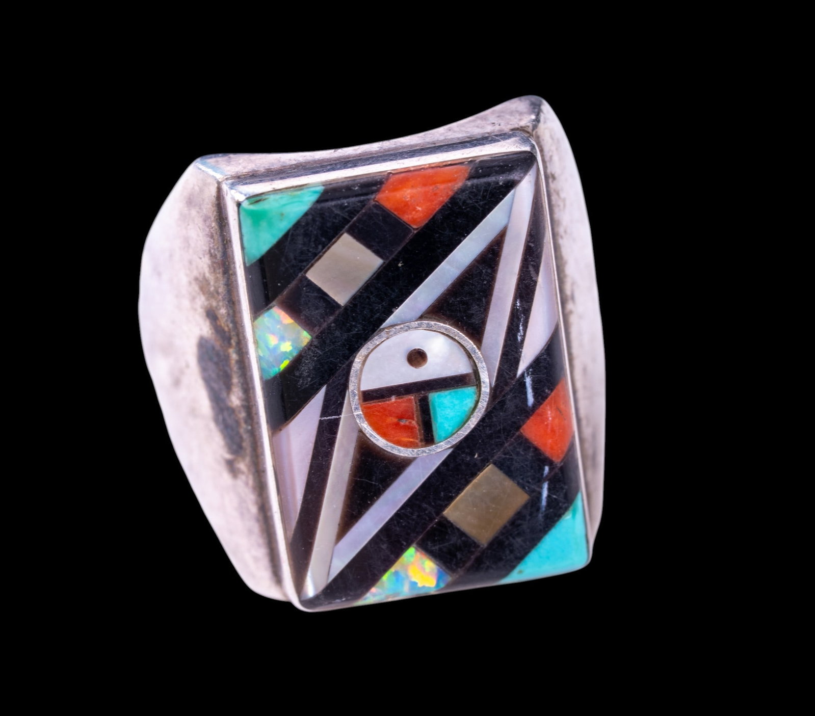 Early Handmade Native American Ring: Large hand wrought silver ring; signed E.O. and inlaid intricately with opal, coral, turquoise and other stone detail.