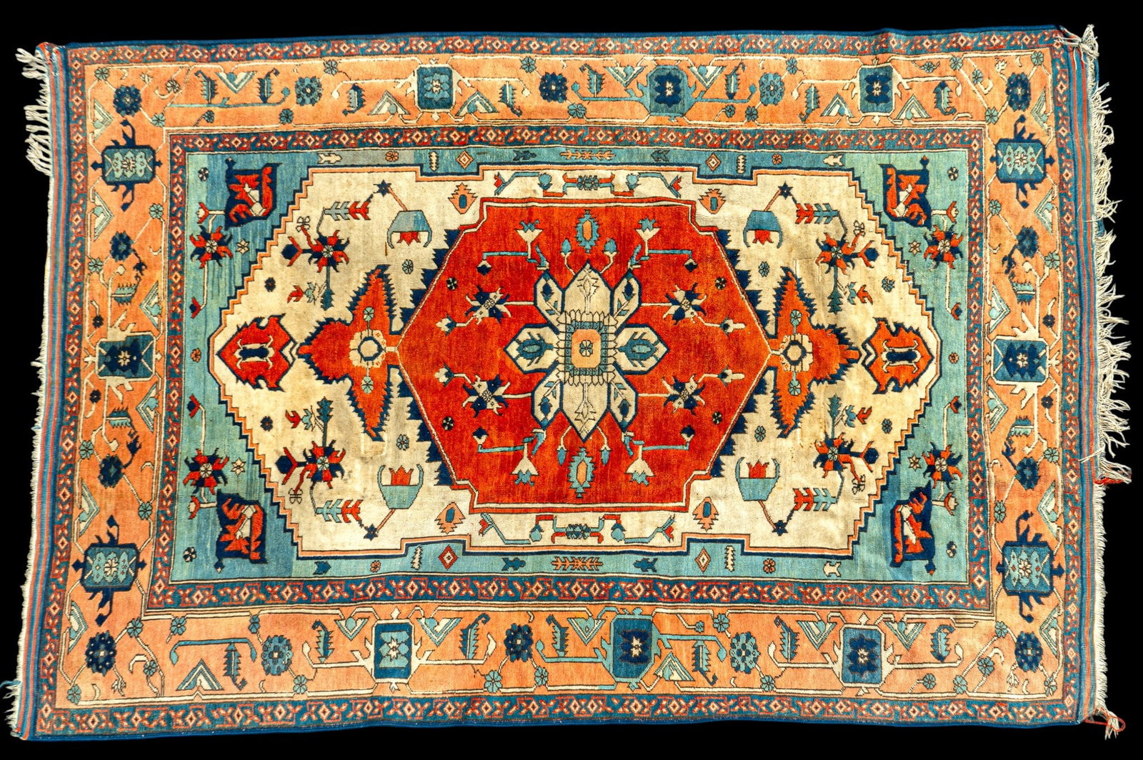 Persian Floral Wool Rug ~7' x 9.75': Persian wool area rug with central maroon medallion surrounded by floral and geometric motifs and peach and blue color border. Measures approx. 6'10" x 9'8".
