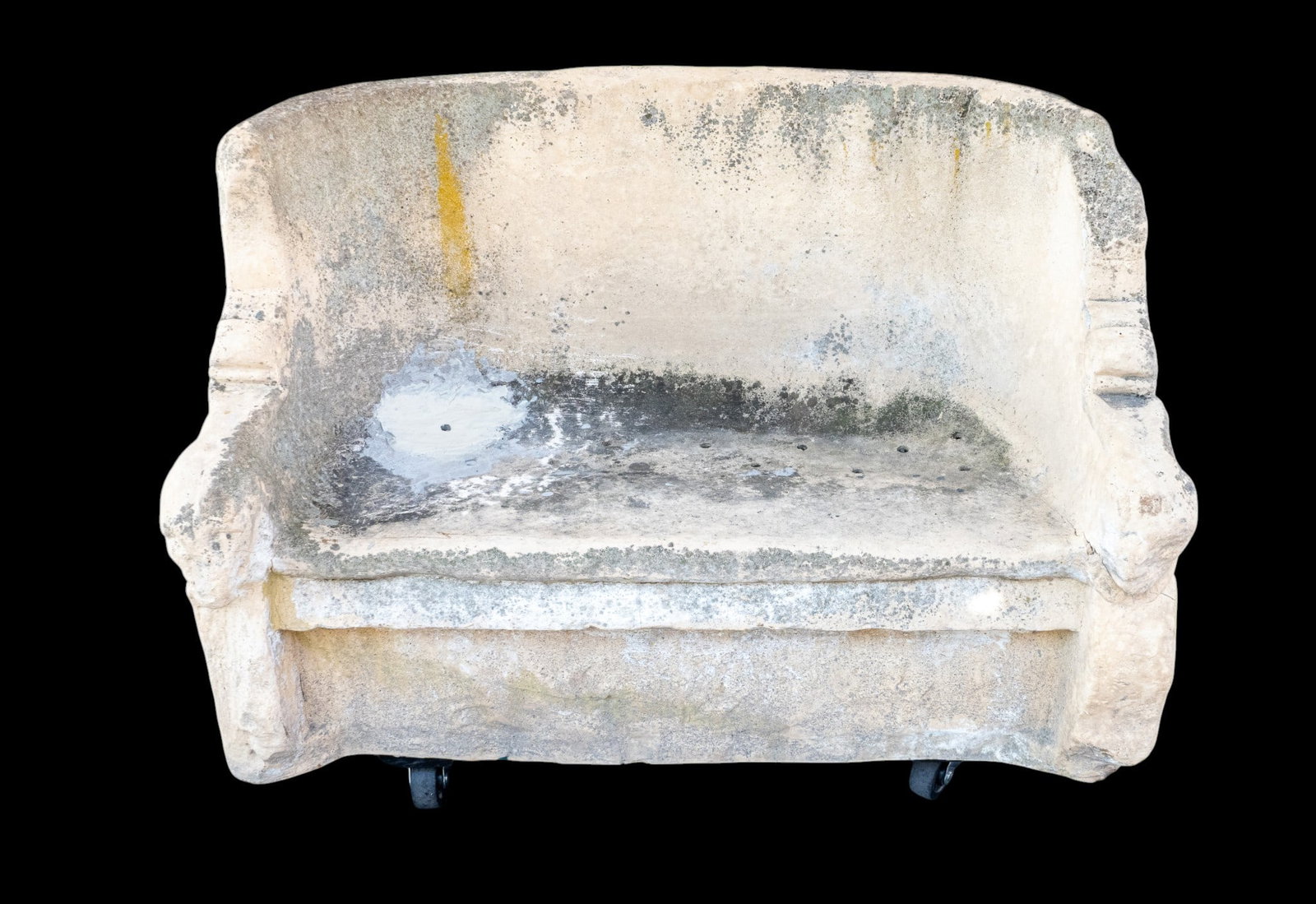 Hollow Cast Garden Bench: Hollow cast garden bench featuring carved winged figures in relief to the reverse and decorative carved detailing to sides and front skirt. One-piece construction with weathered surface and drainage h