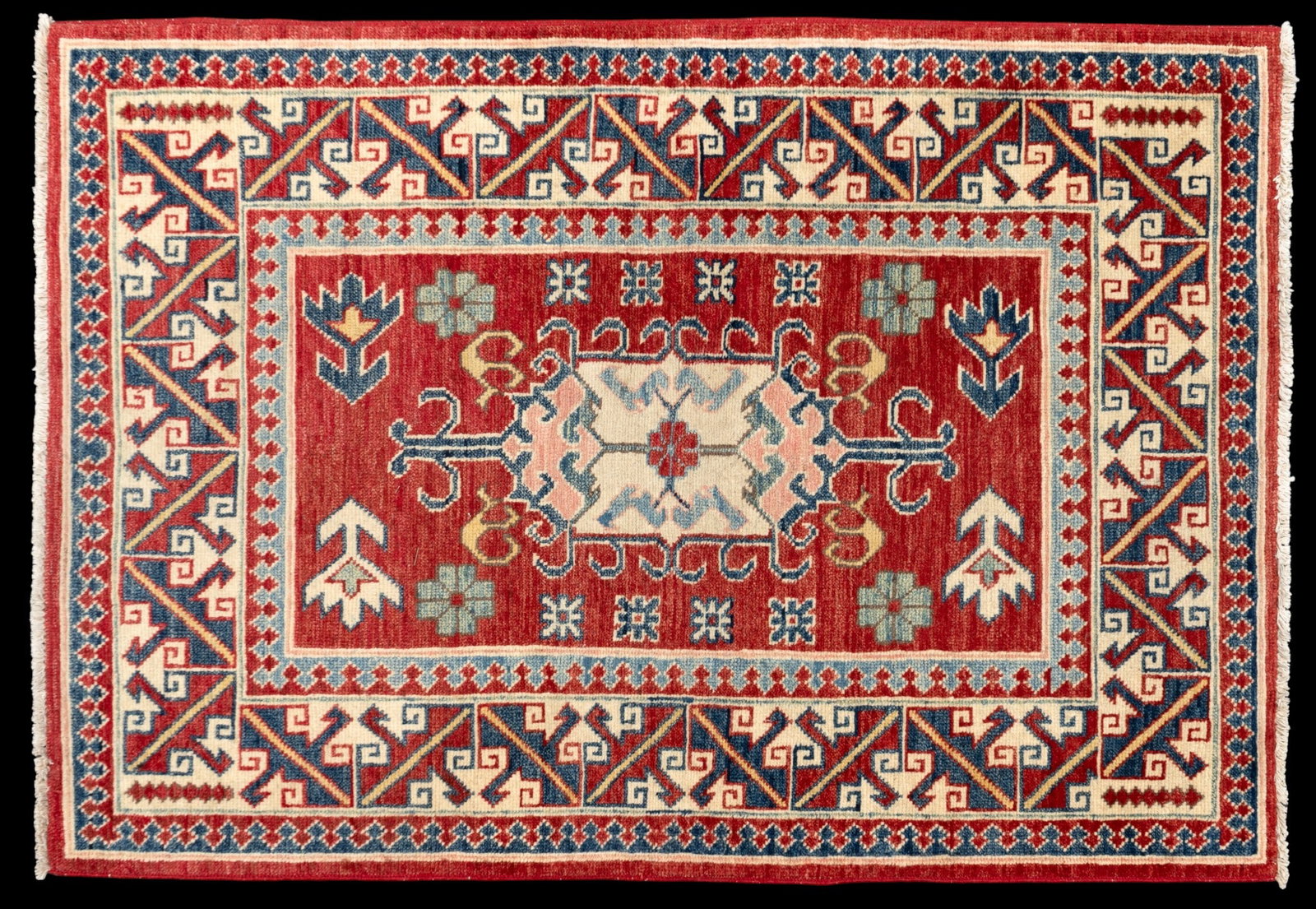 Wool Kazak Area Rug: Red wool Kazak area rug featuring a red field with geometric designs and a central medallion. Measures approx. 3'6" x 5'1".