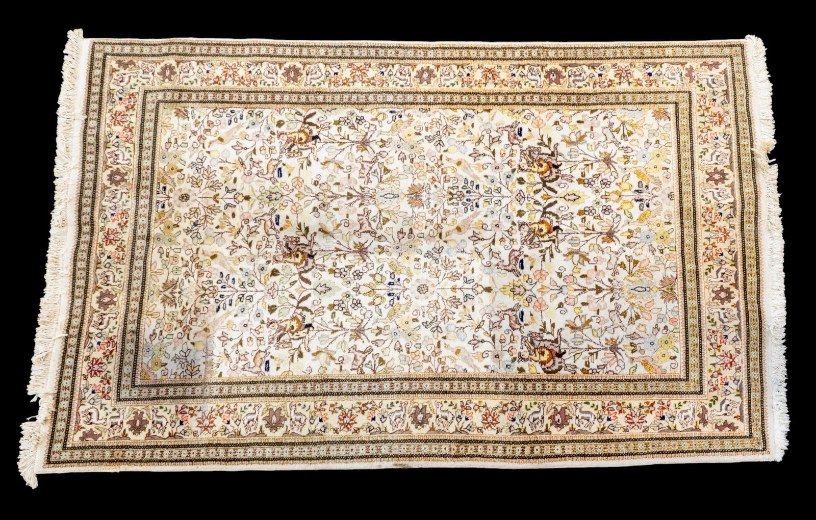 Persian Wool Hunting Rug ~6.25'x9.75': Persian wool area rug featuring dense floral imagery with birds, border with deer and other animals, and men on horseback across the field. Measures approx. 6'3" x 9'9". Note some staining to one corn