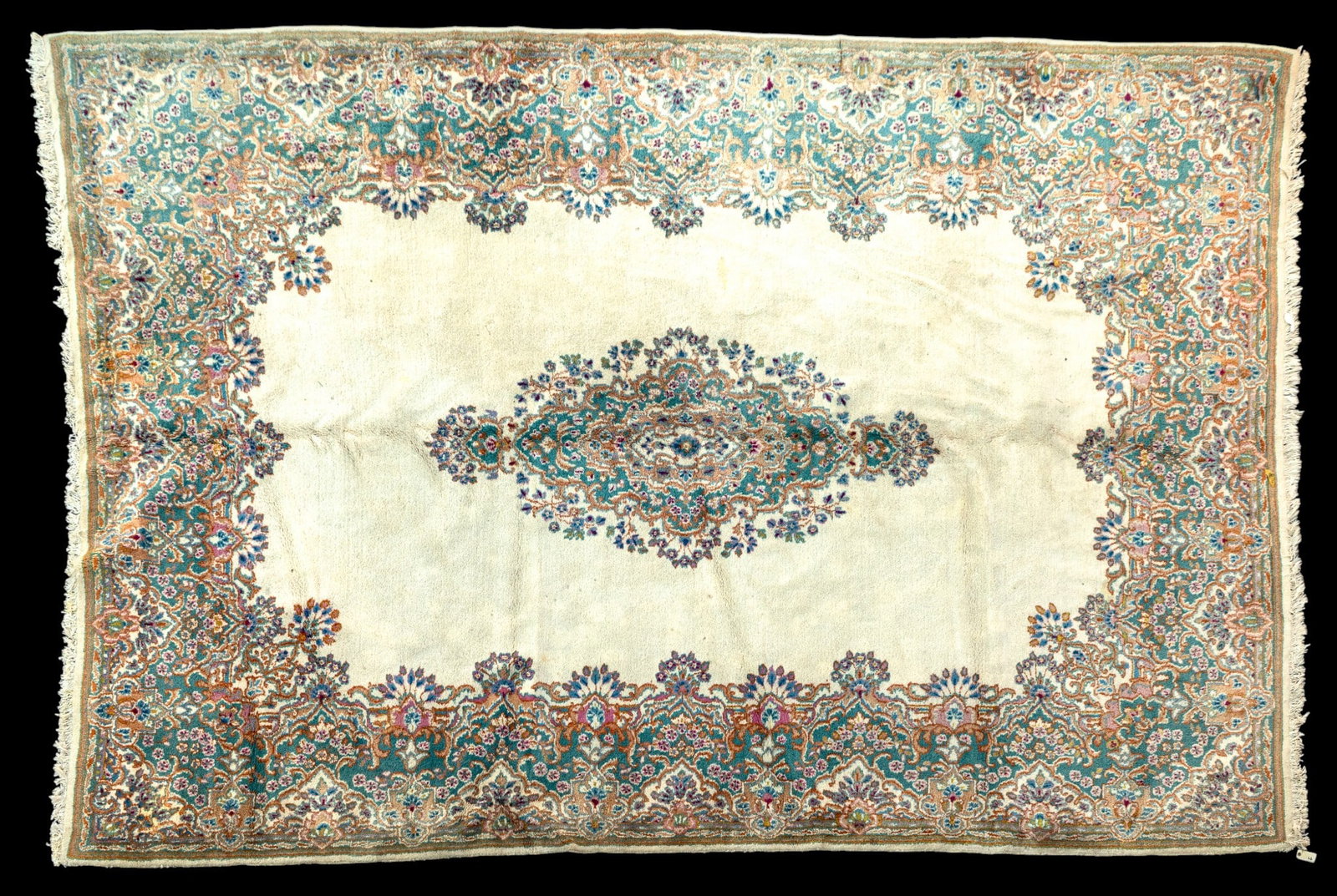 Large Persian Kerman Wool Rug ~ 10' x 14.5': Persian Kerman wool area rug featuring a prominent central floral medallion against a cream field surrounded by dense floral border. Measures approx. 9'11" x 14'5".