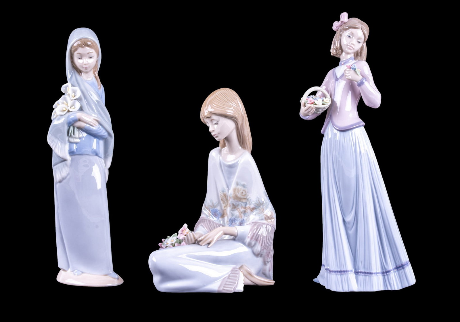 Vintage Lladro Porcelain Figurines: A collection of vintage Lladro porcelain figurines with original boxes including No. 07644 Innocence in Bloom, No. 7.607 Flower Song, and No. 4650 Girl with Calla Lilies. Tallest measures approx. 9.75