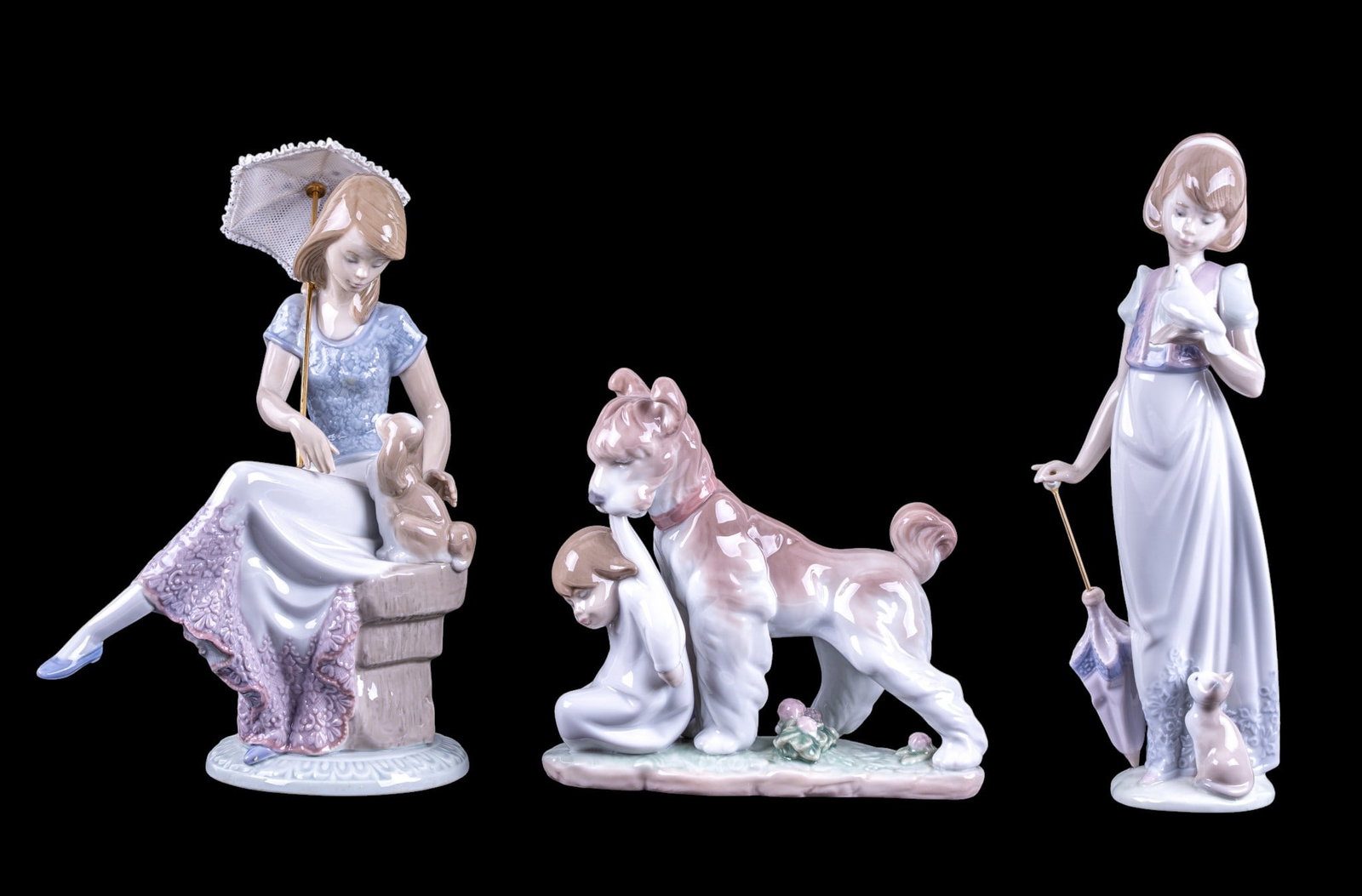 Lladro Porcelain Figurines w/ Original Boxes: A collection of vintage Lladro girl and animal figurines with original boxes including No. 7611 Summer Stroll, No. 06556 Safe and Sound, and No. 7612 Picture Perfect, note umbrella handle has become d
