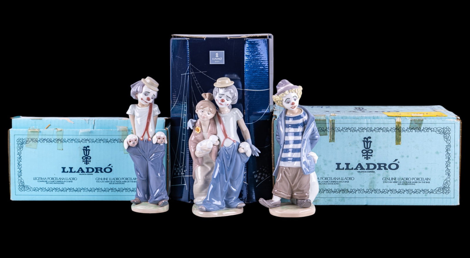 Vintage Lladro Clown Figurines: A collection of Lladro porcelain figurines with original boxes depicting clowns including No. 7.602 Little Traveler, No. 7600 Little Pals, and Lladro Collector's Society No. 07686 Pals Forever. Talles