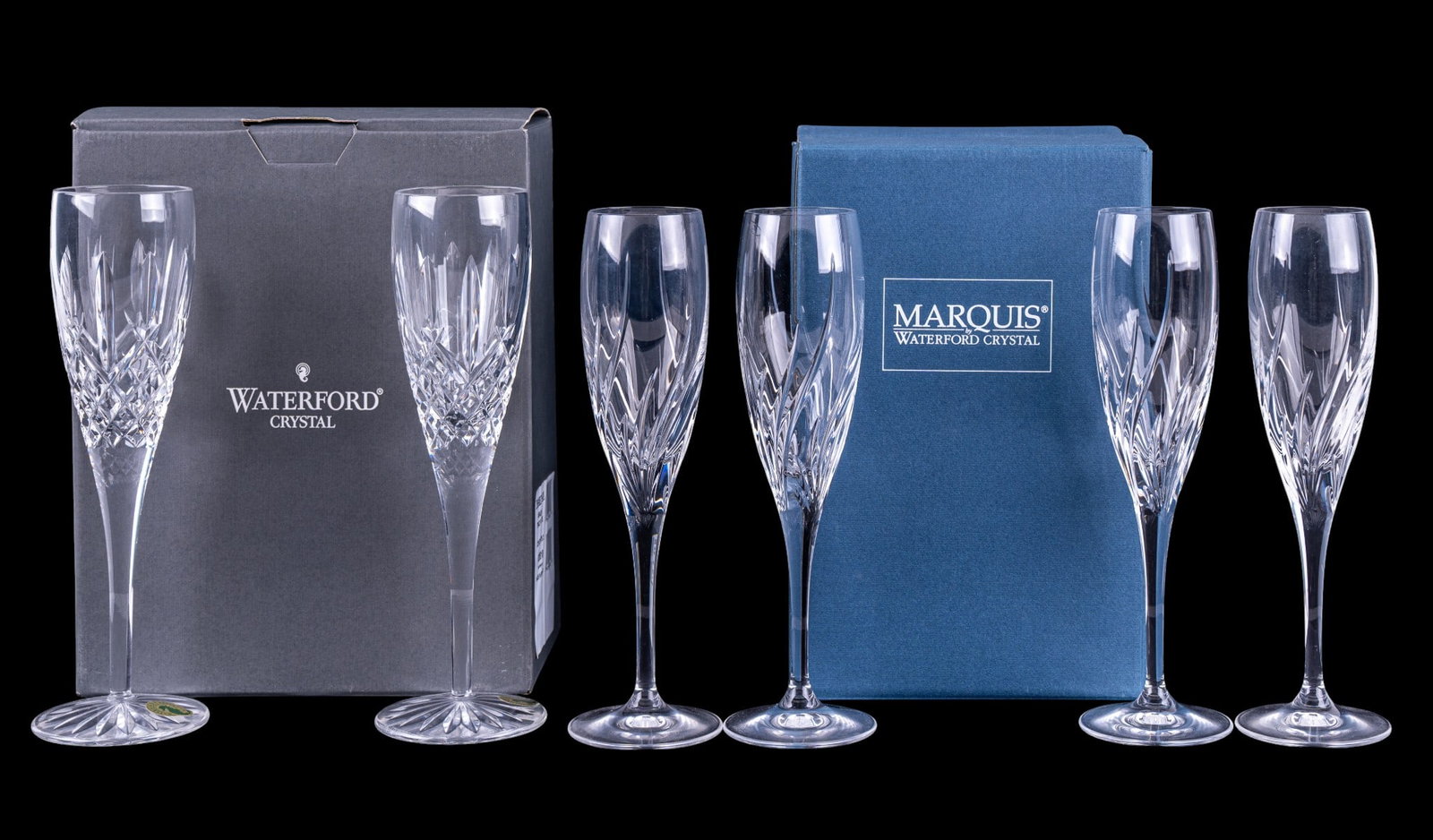 Waterford Crystal Champagne Flutes: A pair of Waterford Crystal champagne flutes in the Araglin pattern, including original box, and a four piece set of Waterford Marquis champagne flutes in the Summer Breeze pattern, including original