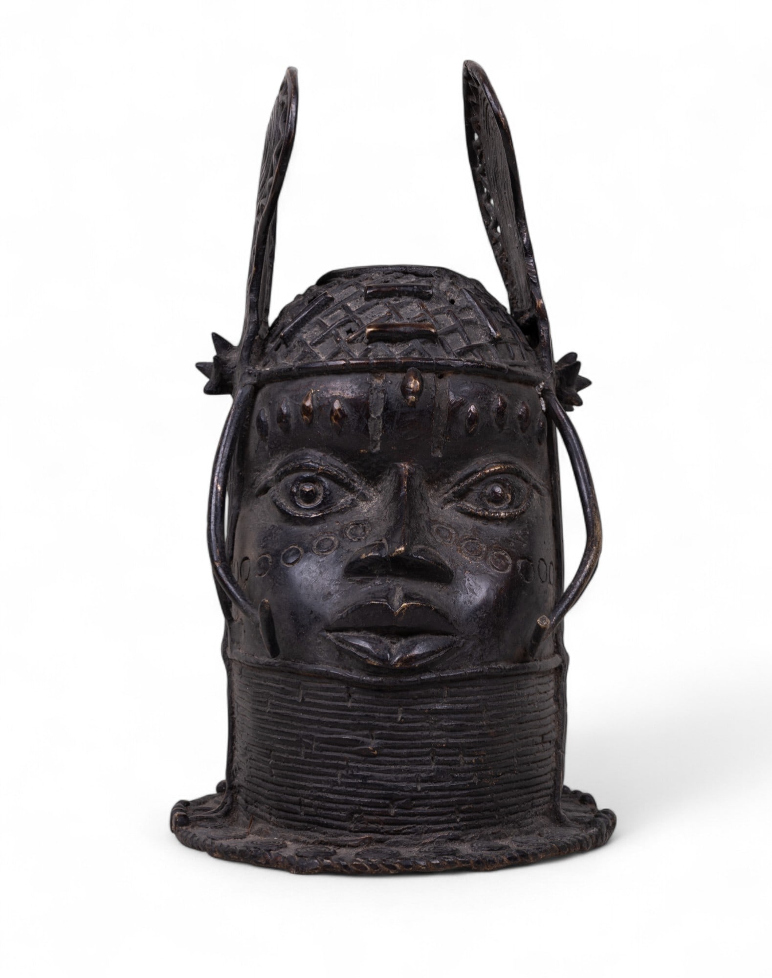 African King Bronze Bust with Wings: African / Benin bronze Oba (King) bust with decorative wings on either side, often commissioned by new Obas to honor their predecessors and placed on ancestral alters. Likely made using Dhokra, a lost