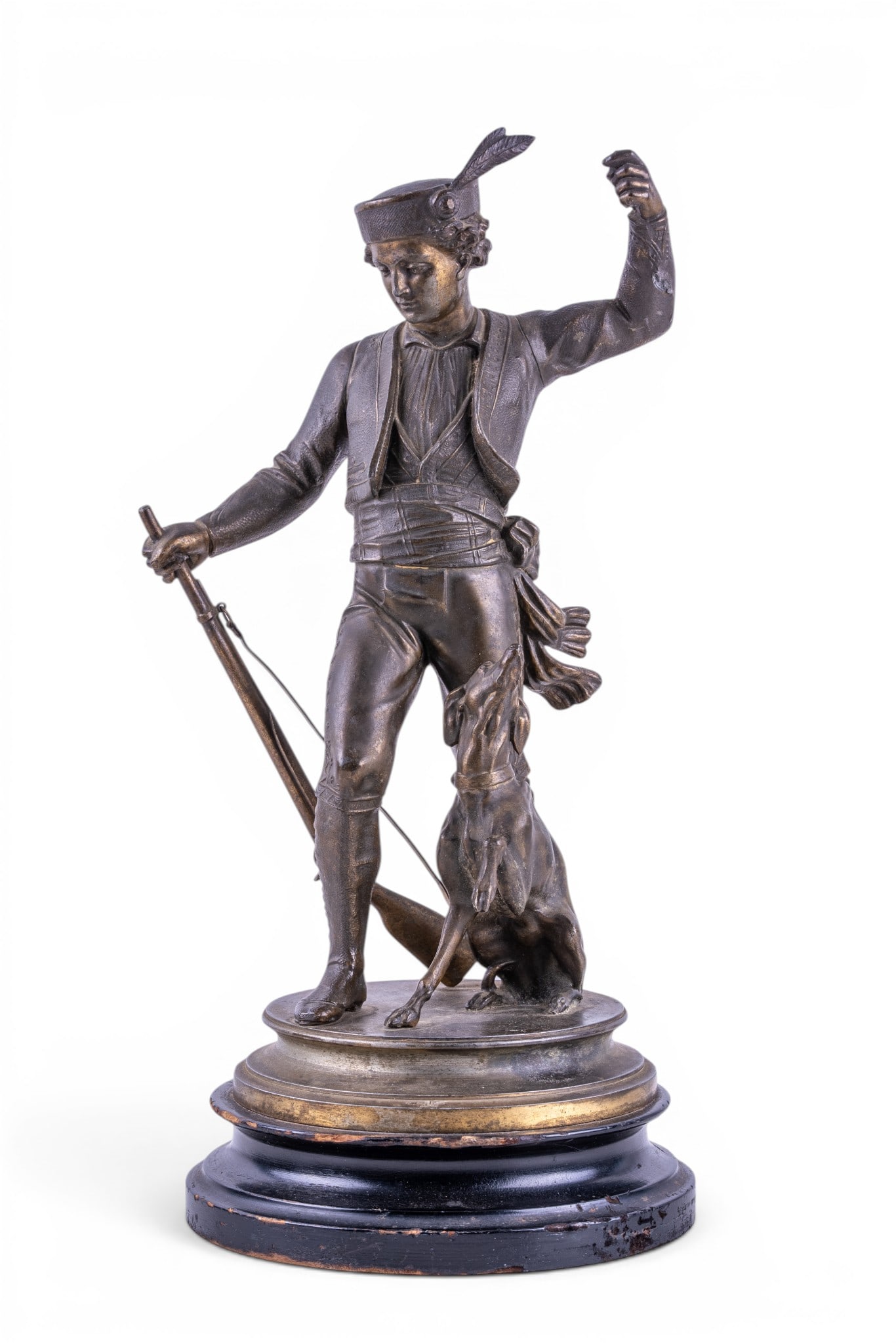 Bronze Figure of a Fox Hunter w/ Dog: Bronze figural sculpture depicting a fox hunter or huntsman standing with a hunting dog at his side, wearing period sporting attire with feathered cap and holding a rifle. Mounted on a circular bronze