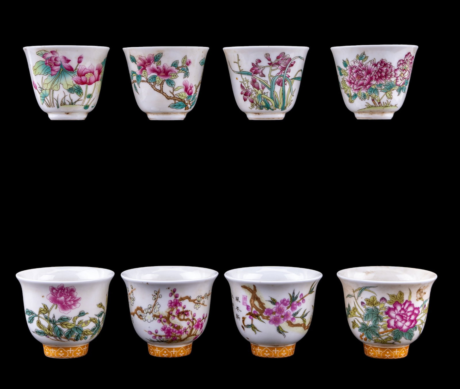 Chinese Porcelain Teacups (8): Collection of eight Chinese porcelain teacups featuring famille rose floral decoration, calligraphy, and gilt accents. Several cups bear 6-character marks while others feature square seal marks. Large