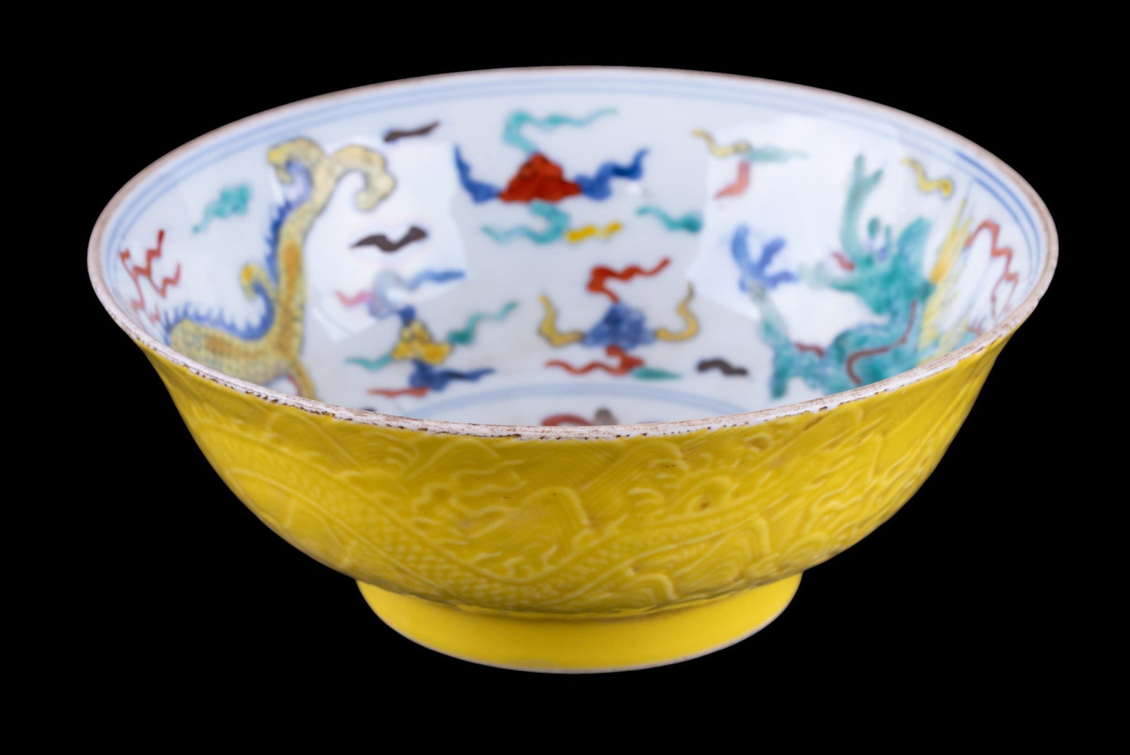 Chinese Yellow-Ground Dragon Porcelain Bowl: Chinese porcelain bowl featuring a yellow exterior with molded dragons in relief. Interior is decorated with 2 dragons surrounding a central dragon medallion. The base bears a mark that translates to 