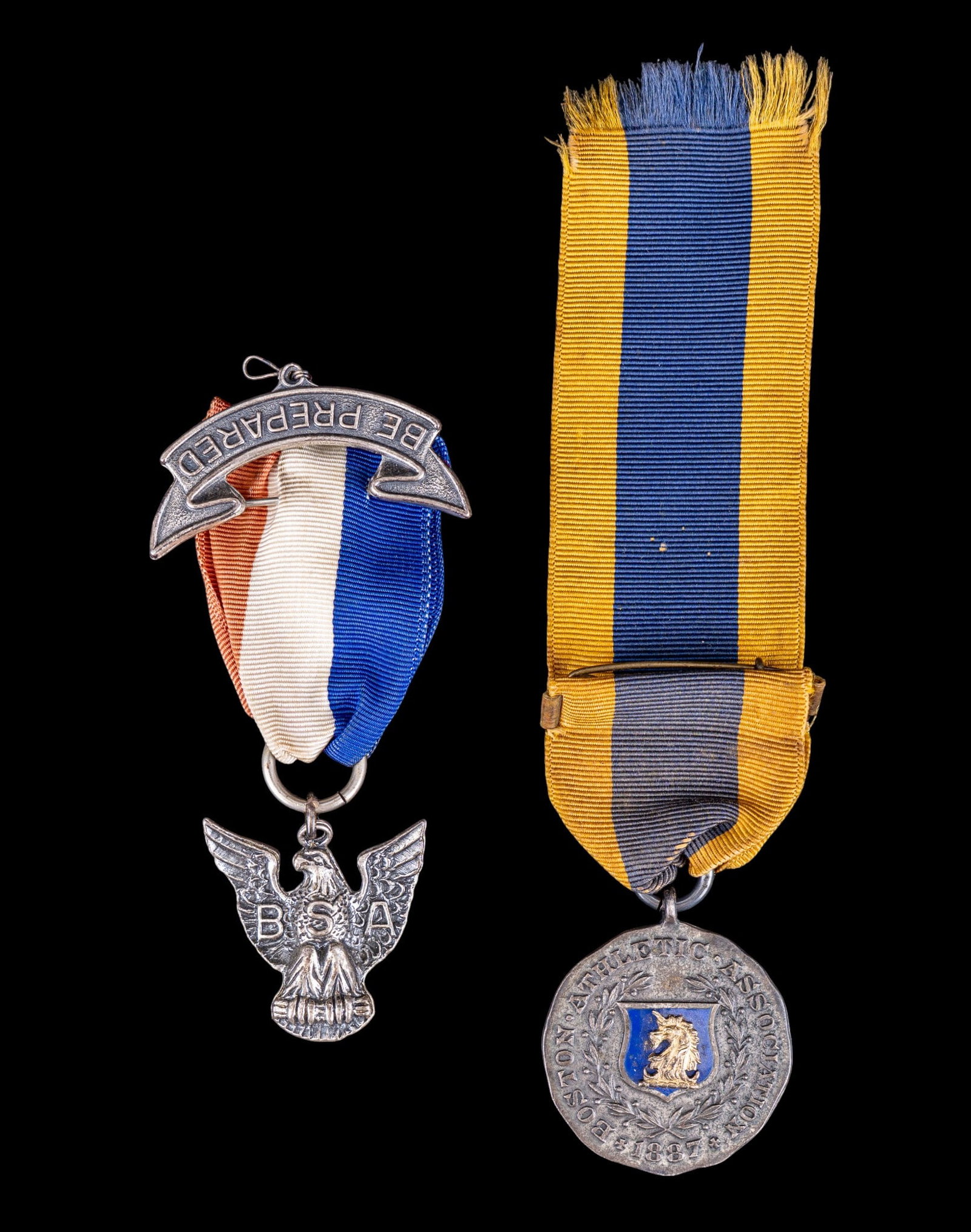 Sterling Silver Fraternal & Athletic Medals: Grouping of two sterling silver medals. Includes a 1918 Invitation Games medal engraved "100 Yards Handicap," dated Feb. 2, 1918, marked Sterling, with yellow and blue ribbon; together with an 1877