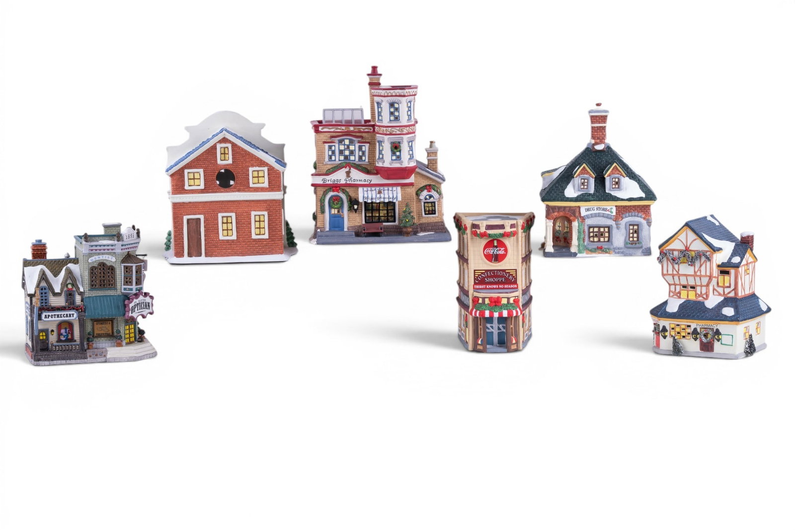 Vintage Pharmacy Christmas Village Scenery: A collection of pharmacy themed vintage Christmas village scenery buildings including Lemax Caddington Village porcelain Optician/Dentist/Pharmacy building, Holiday Living pharmacy/tea house, Heartlan
