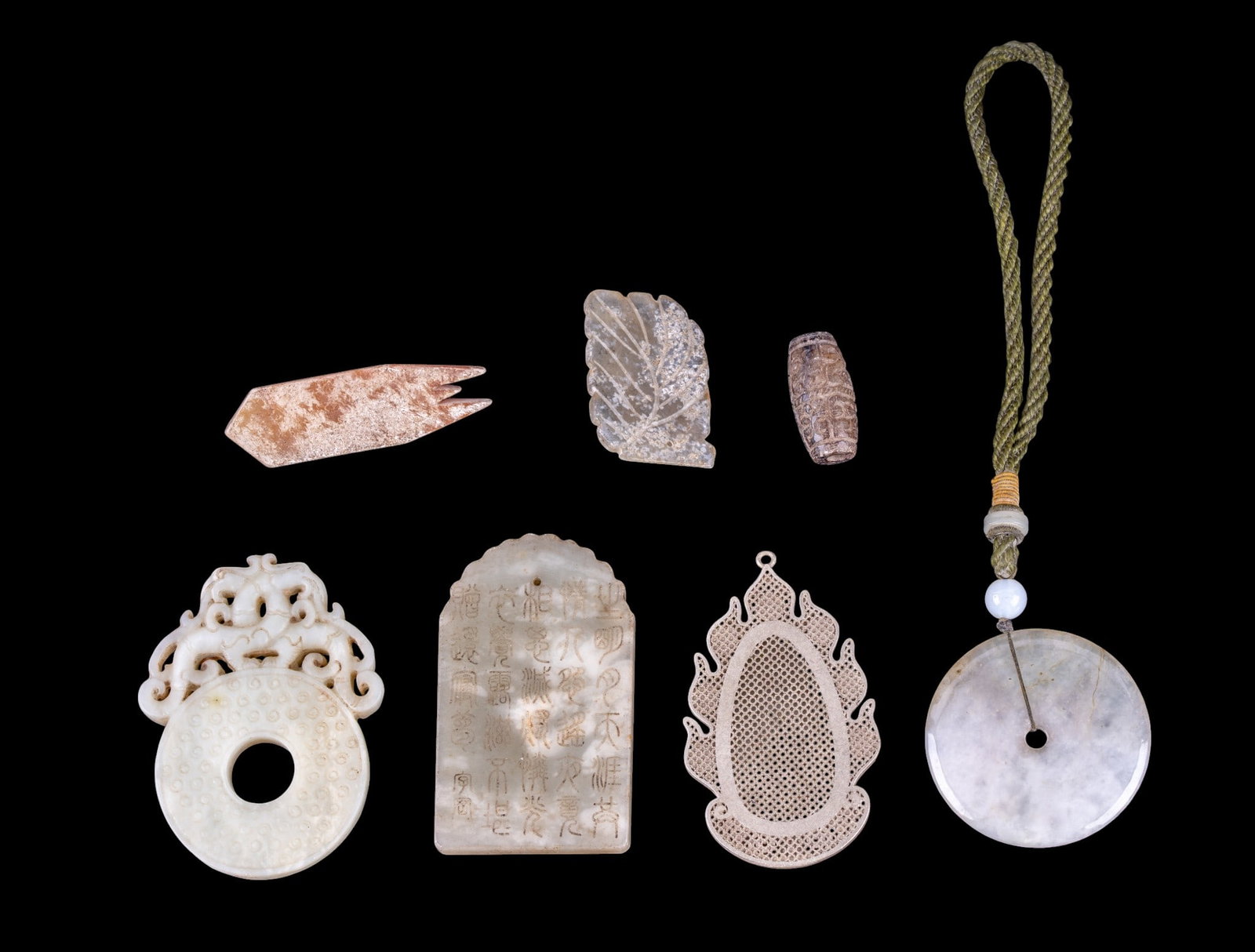 Chinese Hardstone Pendants: A collection of Chinese white hardstone and other stone penfdants and beads.
