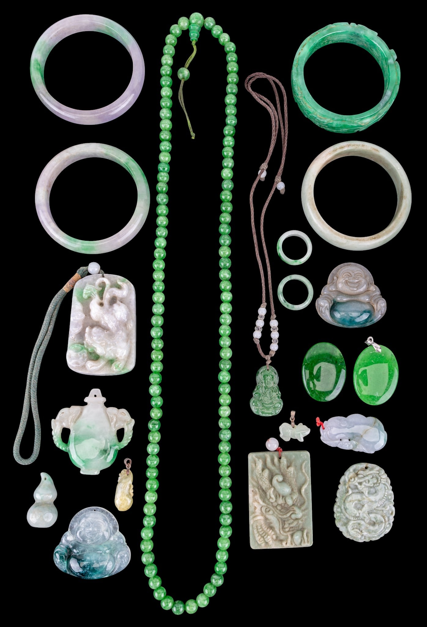 Chinese Green Hardstone Bangles and Pendants: A collection of Chinese green hardstone bangle bracelets, medallions, rings, both size 8, and pendants. All bangle diam is approx. 2.25".