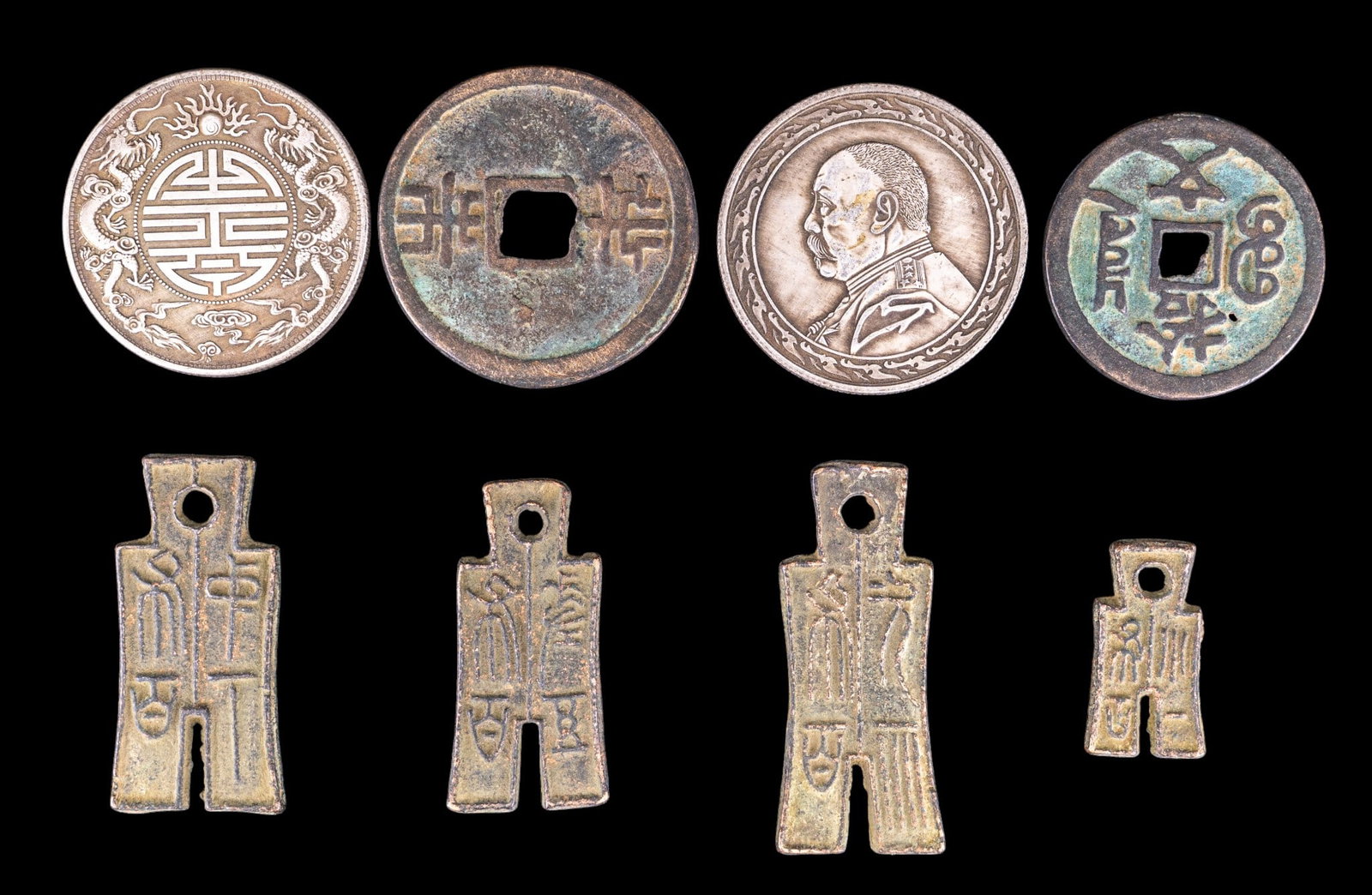 Chinese Coins and Tokens: A collection of Chinese coins and tokens including reproductions of Chu State spad3e money, bronze cash coins, Republic era 1 Yuan "Fat Man" coin, and and a double dragon Guangxu Yuanbao.