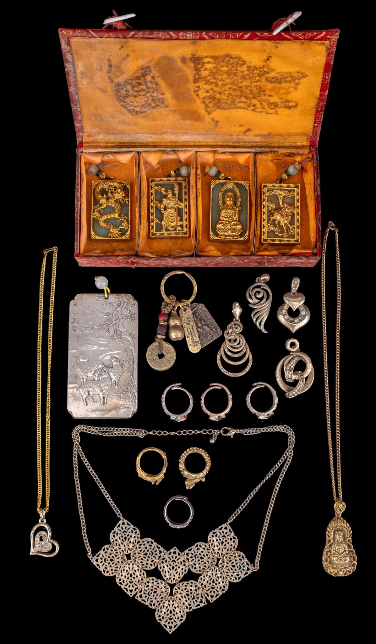 Chinese Hardstone and Other Costume Jewelry: A collection of Chinese costume jewelry including gold and silver tone adjustable rings, necklaces, pendants, and a set of four gold tone and green hardstone medallions featuring dragons, Buddha, and 