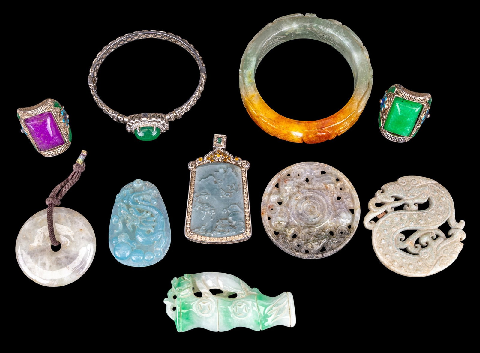 Chinese Hardstone Medallions & Jewelry: A collection of Chinese hardstone dragon and other medallions and pendants, a dragon and phoenix bangle, approx. 2" inner diam., a hinged cuff with green hardstone cabochon, and two hardstone and
