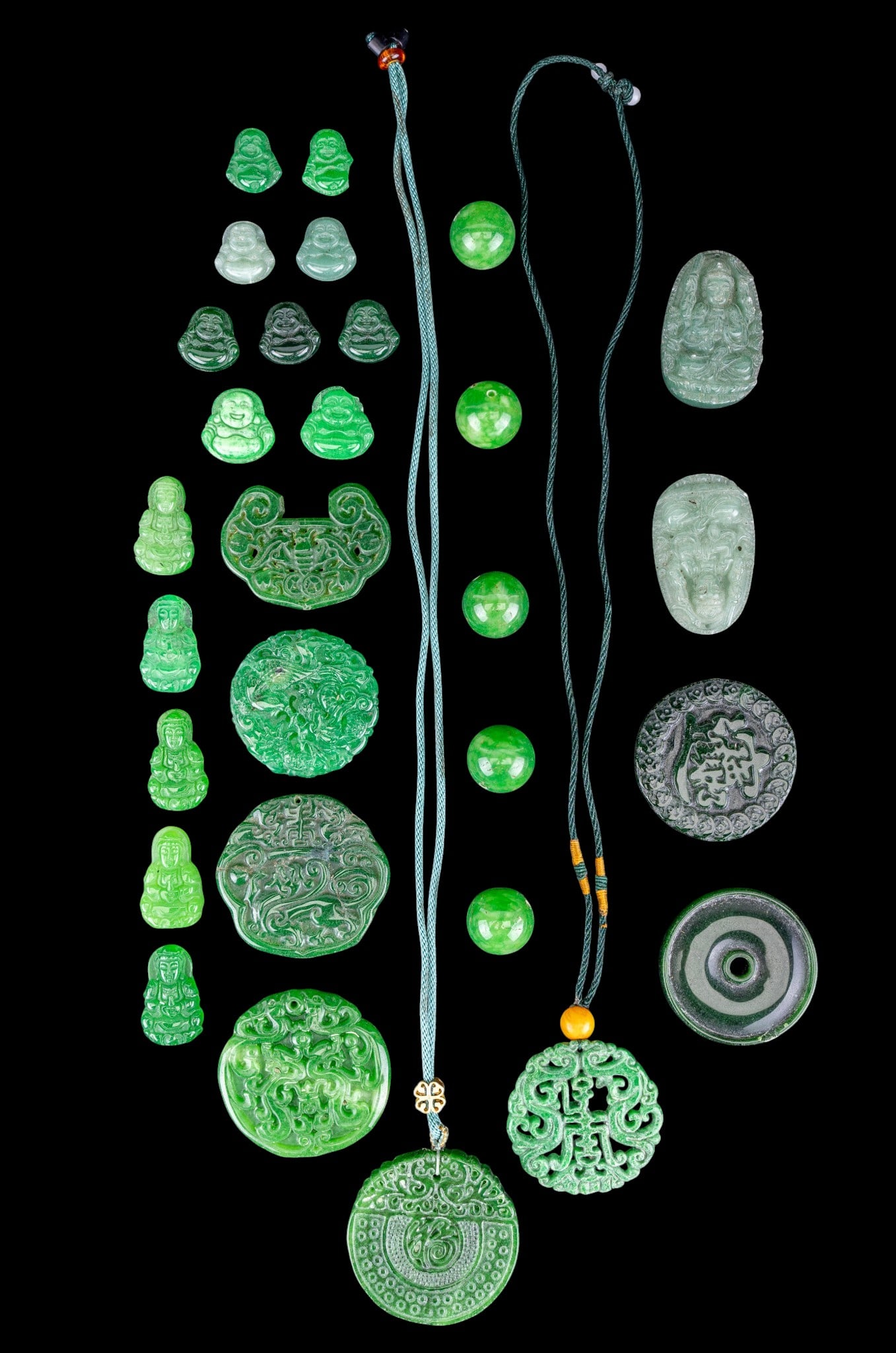 Chinese Green Hardstone Medallions: A collection of Chinese green hardstone dragon and Buddha medallions, beads, and tokens. Note some pieces are dyed.