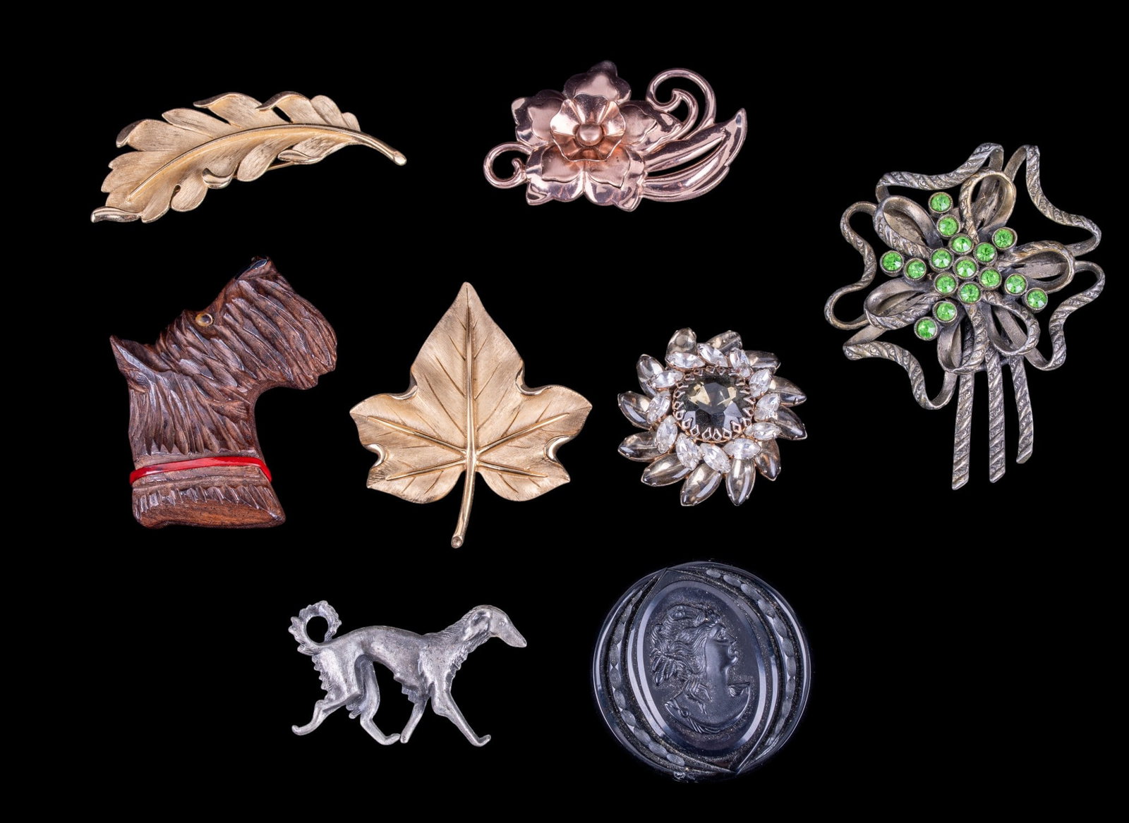 Trifari and Vintage Pins: Two leaf shaped gold tone Trifari brooches, 2 rhinestone pins, Victorian brooch of a woman, and a large carved Scottie dog brooch.