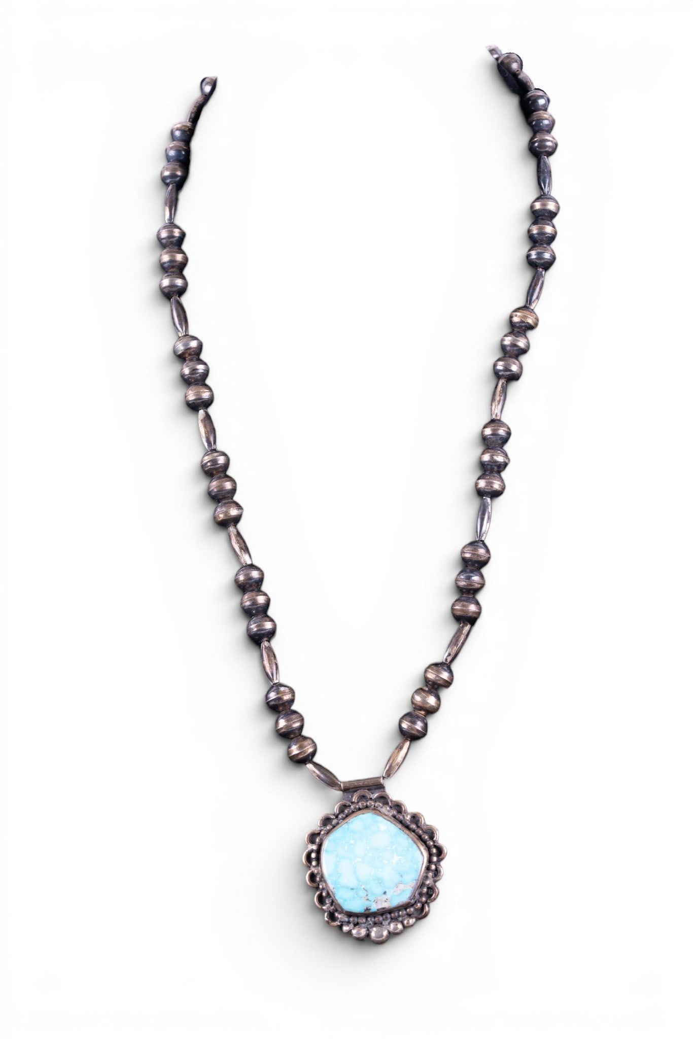 Native American Necklace: Handmade and stamped by maker (on reverse of pendant), silver bead necklace and silver pendant set with a large piece of turquoise.