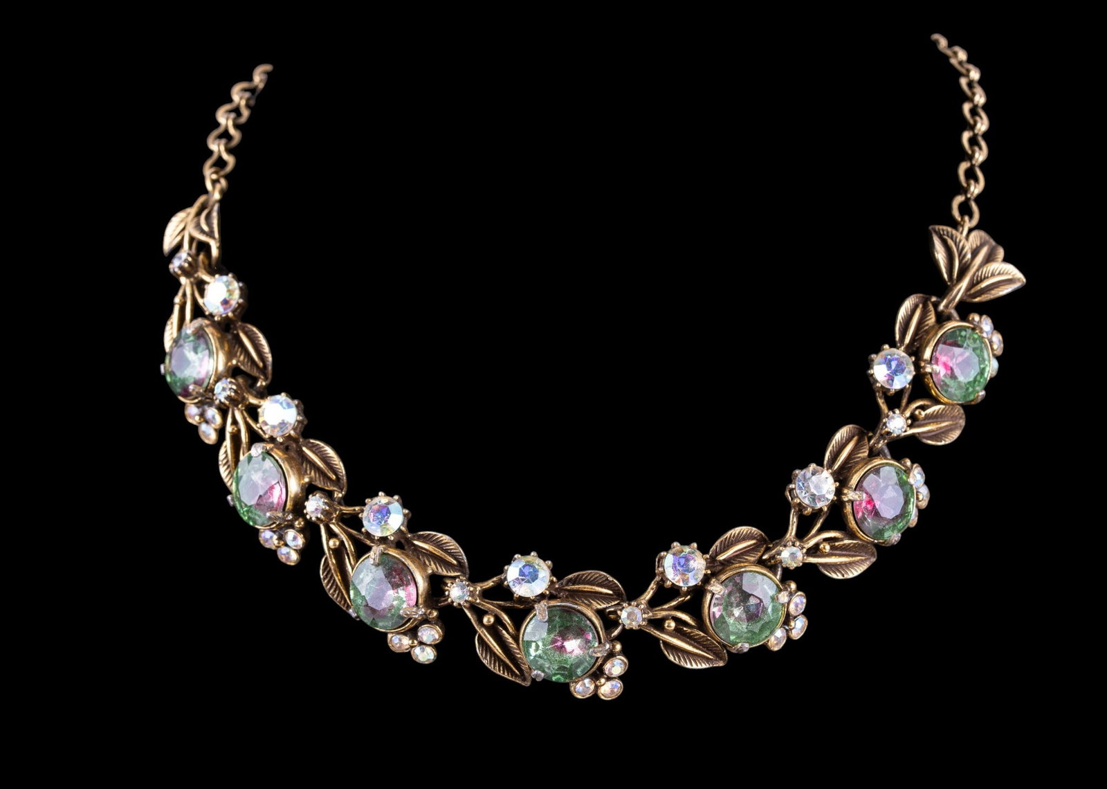 Vintage Florenza Iridescent Stone Necklace: A fine vintage floral motif gold tone necklace featuring iridescent cut stones and round cut stones that resemble watermelon tourmaline, by Florenza, measures approx. 7" L on the drop.