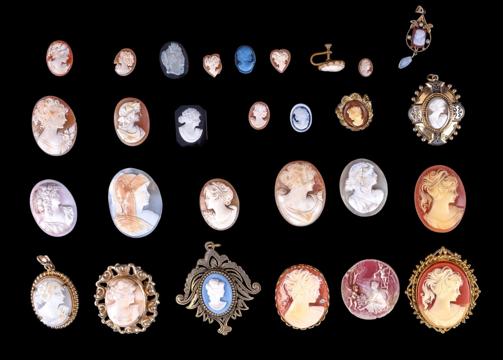 Antique and Vintage Cameo: A collection of antique and vintage cameos, some carved carnelian, some are acrylic, including a gold tone Victorian etched locket, an Art Nouveau pendant, a faux carnelian brooch by Lisner, and more.