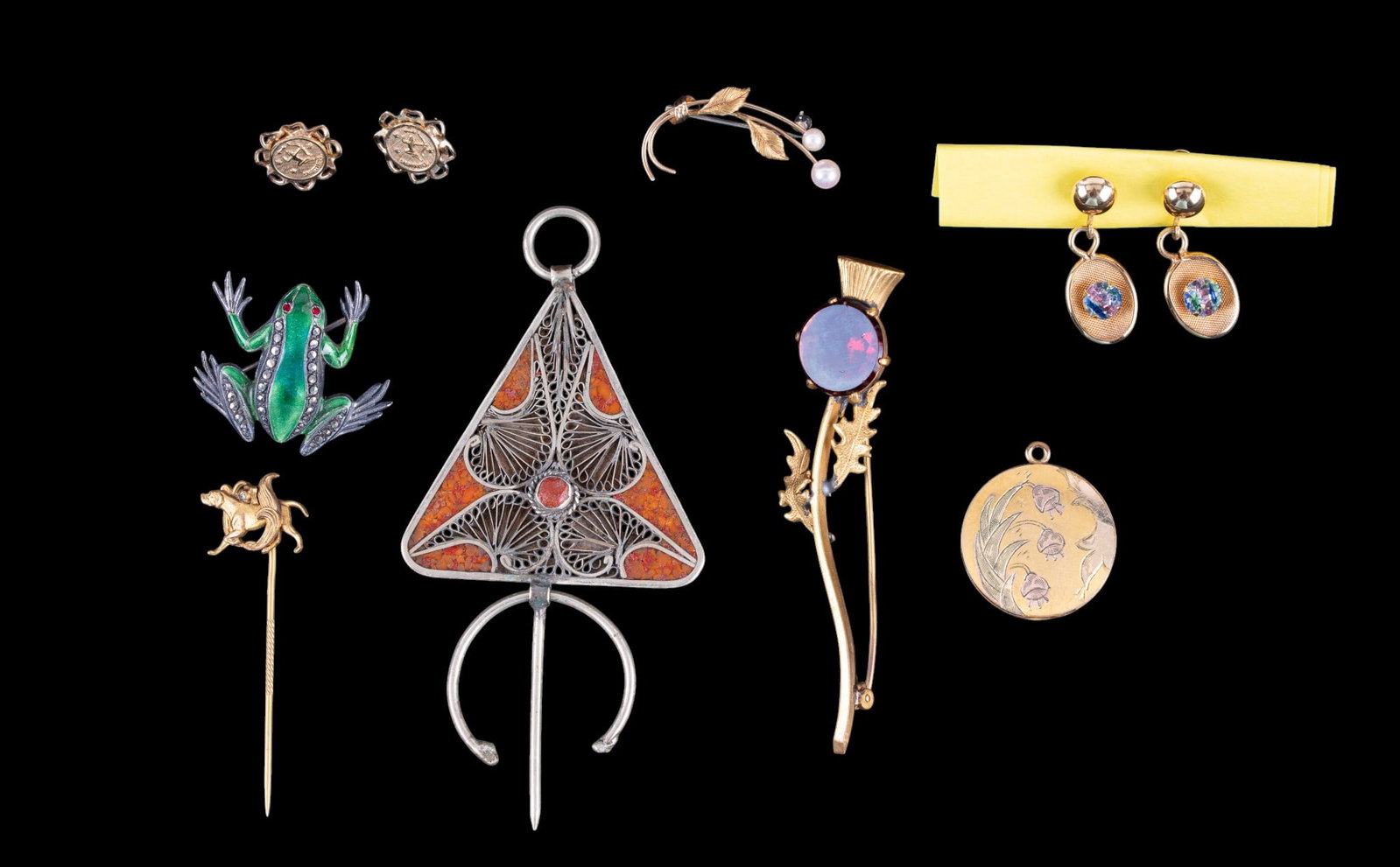 Gold Filled and Sterling Jewelry: A collection of marked and unmarked gold filled and sterling jewelry including a marked sterling silver enamel and rhinestone frog brooch, unmarked gold filled brooches, stud earrings, and equestrian