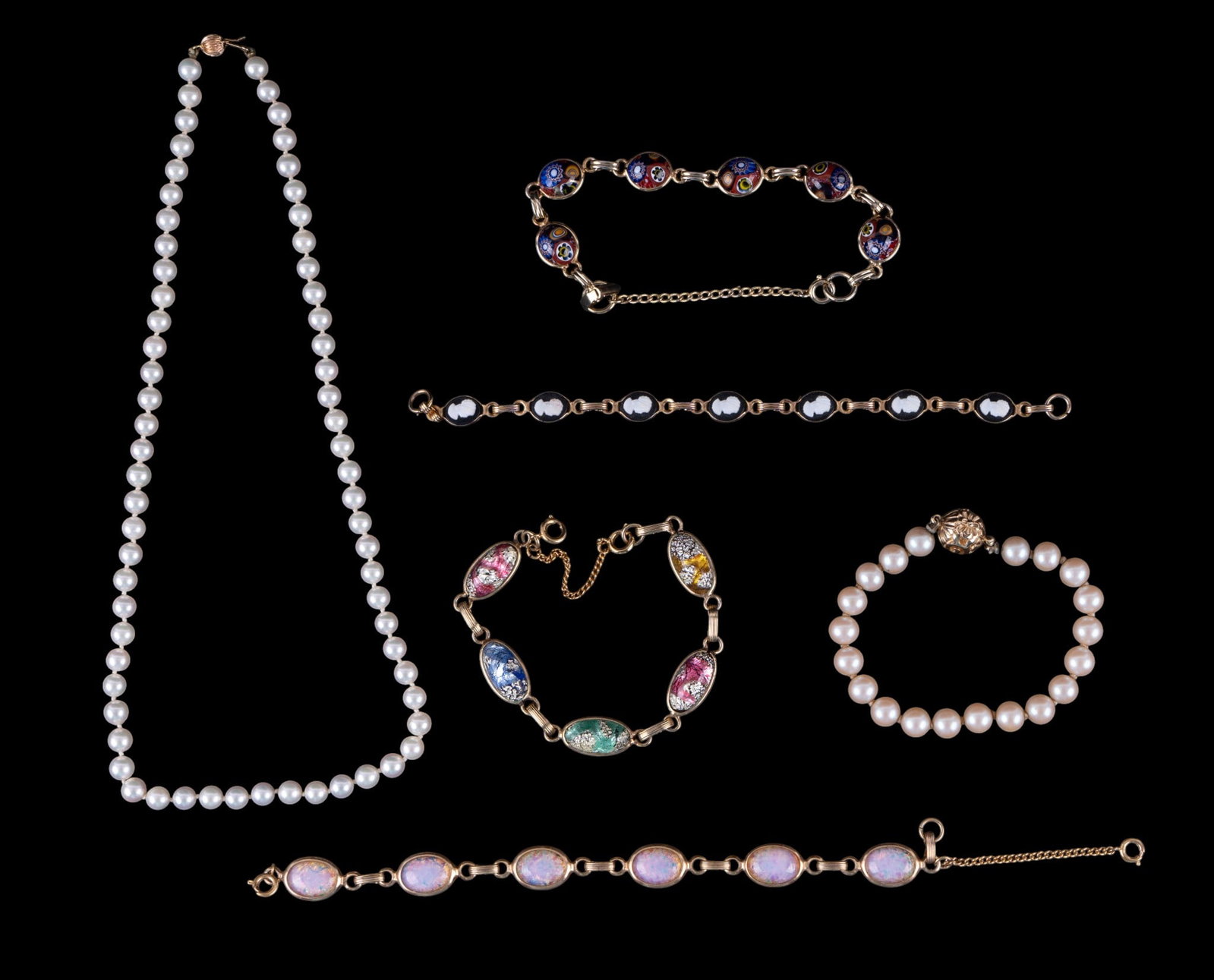 Vintage Bracelets and Pearl Necklace, 14K Clasp: A pearl necklace with 14K gold clasp, and an assortment of vintage mid century gold tone and pearl bracelets. Necklace measures approx. 9" L on the drop.