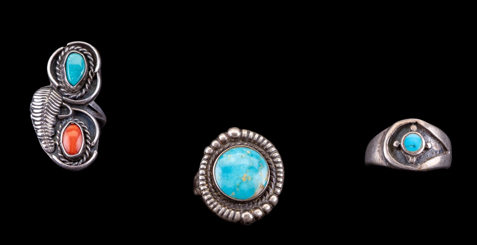 Early Sterling and Turquoise Rings (3): A collection of 3 sterling rings featuring turquoise cabochons, one also contains a coral cabochon, two rings are not marked/signed. Sizes range from 5 to 9, total weight is approx. 0.6oz.