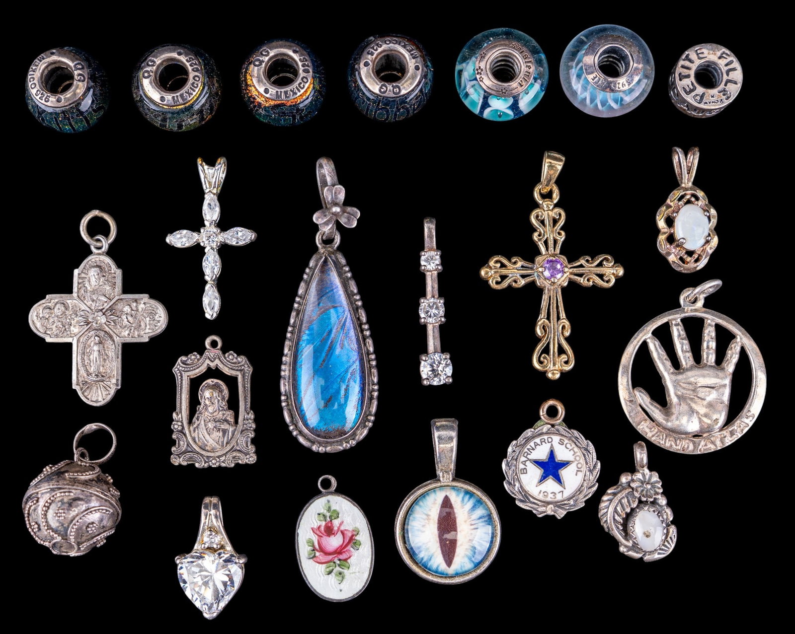Sterling Cross Pendants, Pandora and Other Charms: A collection of sterling silver Cross pendants, religious medallions, antique butterfly wing pendant, a sterling feather pendant signed 'MJ', an assortment of Pandora art glass and sterling charms,